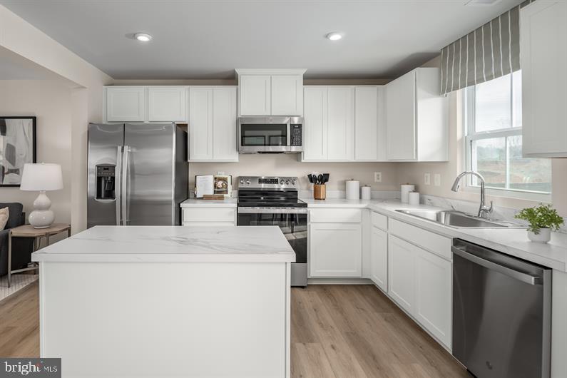 LEHMANS LANDING TO BE BUILT JUNIPER. HOMESITE BACKS TO WOODS PROVIDING EXTRA PRIVACY AND IS LOCATED NEXT TO THE MODEL HOME BUILDING. This community is just 2 miles from downtown Carlisle, bringing new townhomes with 1-car garages to a location that keeps you close to everything that makes it easy to live your life your way—with modern spaces and a vibe that fits.

The Juniper floorplan combines all the amenities of single-family living with total convenience. The main living level is highlighted by a gourmet kitchen that's open to the living area so you'll never miss a moment. Choose the optional island for more workspace. A dining area provides room for entertaining or cozy evenings at home. Upstairs, three large bedrooms offer plenty of closet space and a generous hall bath. The luxury owner's suite is a quiet retreat with its own full bath and huge walk-in closet. The entry level provides easy access from the front door to the garage and an optional door for back yard access.  Your entrance gives you  privacy as well as making it easy for you to get to wherever you need to go. The entry level also has plenty of storage space and an option to finish off additional living space that could be used as a TV room, study, or office.

Let us show you the value of new construction and forget the costly repairs and maintenance of an older home. We stand by our homes; included is a new home warranty giving you the peace of mind that you deserve. Call to schedule your tour today and discover all The Juniper has to offer! A DECORATED JUNIPER MODEL IS AVAILABLE TO WALK THROUGH!!! Photos are representative only.