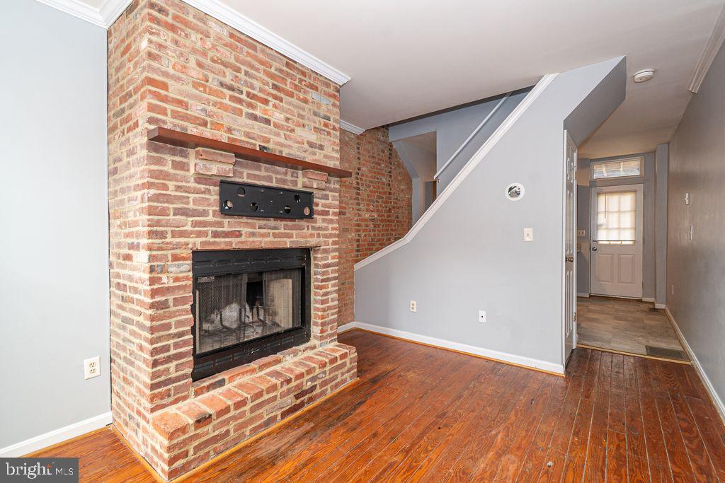 End of Group in Federal Hill.. move in ready home with gleaming hardwood floors (1st and 2nd floor), fireplace and a great view. On the main level enjoy the stylish kitchen with granite countertops and stainless appliances. Upstairs there are 2 bedrooms, and full bath. As you make your way through the house take a look at the large rooftop deck with the best views of federal hill to the Inner Harbor. The finished basement with bath offers extra living space for entertainment, or a third bedroom.  Let's not forget the fenced in backyard for privacy. Located close to shopping, restaurants, pubs, and more. This is a must see.