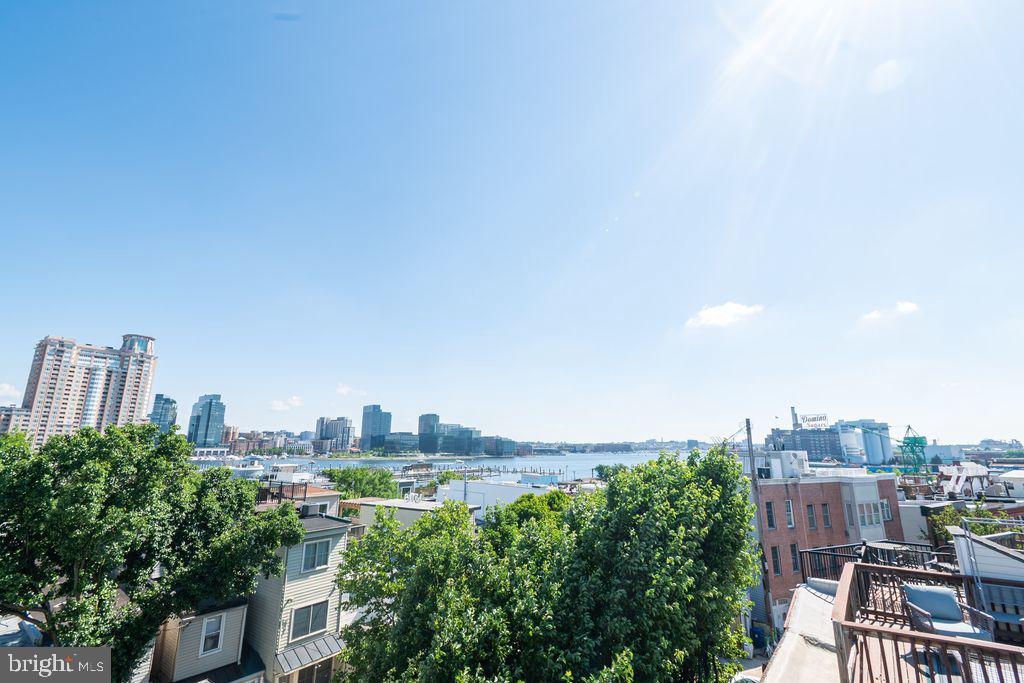 Relax and Entertain to this water view. End of Group charming brick-front home in the heart of Federal Hill offering 2 bedrooms, 2 full baths, with sought-after water/ city views from the rooftop deck  with grill. On the main level.. enter into the living room with gleaming hardwood floors, with brick fireplace, a stylish kitchen with granite countertops and stainless appliances which leads to the fenced backyard. 
Upstairs the owners suite offers hardwood floors an exposed brick wall. The finished basement with bath offers extra living space for entertainment, or a third bedroom. New HVAC system.  Located close to shopping, restaurants, pubs, and more. Great home for city living or an investment property with strong  rental comps. Charm, Character, and location here.