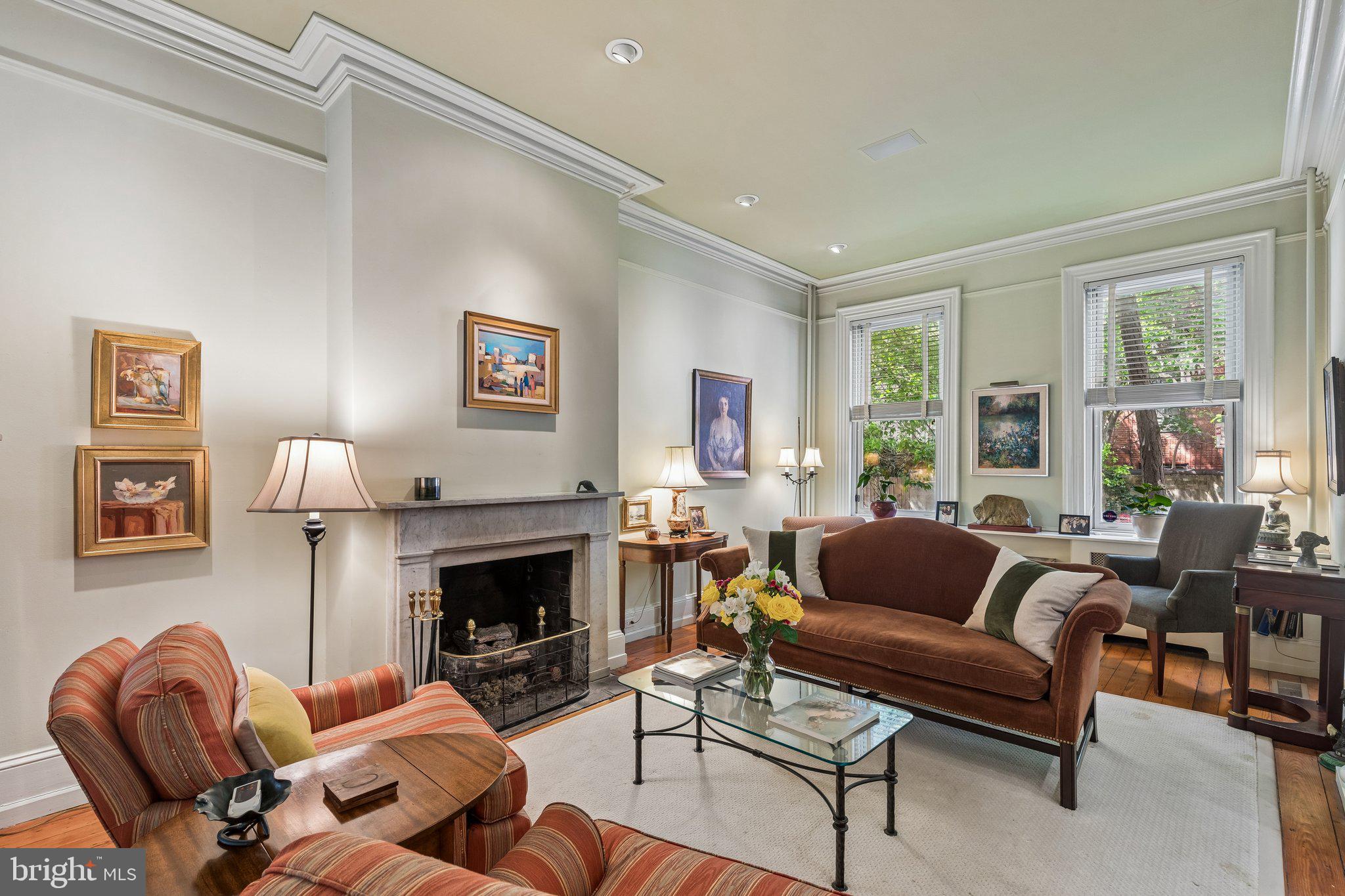 Positioned on one of the most sought-after, tree-lined blocks between Rittenhouse Square and Fitler Square—and within the highly coveted Greenfield School catchment—2206 Locust Street presents a rare opportunity to own a gracious, well-scaled historic townhouse that seamlessly blends classic architectural character with everyday livability. Surrounded by timeless brick and stone facades, the home enjoys a quiet, residential setting just moments from the vibrancy of Center City, while also offering the exceptional convenience of secure gated parking directly at your back door—an invaluable amenity in this prime urban location.
A welcoming entry introduces high ceilings, original hardwood floors, and refined detailing that carry throughout the home. The formal living room sets a tone of understated elegance, featuring crown moldings, a marble gas fireplace, and stately pillars that frame the space with architectural presence. From here, the home flows naturally into a formal dining room, with a transitional nook offering flexibility for additional storage or future customization. The dining room itself is bright and generously proportioned—well-suited for both intimate meals and larger-scale entertaining.
To the rear, a thoughtfully designed kitchen features natural cherry cabinetry accented by stainless steel pulls, along with stainless and black appliances that complement the space’s timeless aesthetic. A breakfast room extends the kitchen and is illuminated by a skylight that fills the area with warm southern sunlight—creating an inviting setting for casual dining or morning routines. French doors open directly to a private garden, creating a seamless indoor–outdoor connection ideal for morning coffee, container gardening, al fresco dining, or quiet evenings under the stars. Accessed through a flush floor entry, the full-length basement below is currently utilized as an artist studio, workshop space, and darkroom—offering exceptional flexibility for creative or practical use.
Up a graceful curved staircase, the second floor reveals a well-balanced layout. At the rear, a spacious family room with a gas fireplace and bay window provides a comfortable secondary living space, filled with natural light. A hall bathroom and conveniently located powder room with stacked washer and dryer serve this level. At the front, the primary suite enjoys northern exposures and features a built-in bookshelf, a walk-in closet, and an en-suite bath appointed with limestone tile and a glass-enclosed tub and shower combination.
The upper level is accessed by dual staircases and offers three additional bedrooms arranged around a full bathroom. The front bedroom is complemented by an adjoining den and ample closet space, while the rear bedroom is gracious in scale and distinguished by hardwood floors and a charming arched detail—echoing the home’s classic architectural language. A shared bath with a glass-enclosed shower completes this floor.
Ideally located just steps from neighborhood parks, renowned dining destinations, and some of Philadelphia’s most respected institutions—including University of Pennsylvania, Drexel University, and Children's Hospital of Philadelphia—this residence offers a compelling blend of space, character, and convenience. With easy access to the Schuylkill River Trail and major transit routes, daily life here is both connected and serene.
Elegant, inviting, and rich with original detail, 2206 Locust Street offers a timeless interpretation of Center City living—where historic charm, functional design, private outdoor space, and secure gated parking come together in a truly exceptional home.