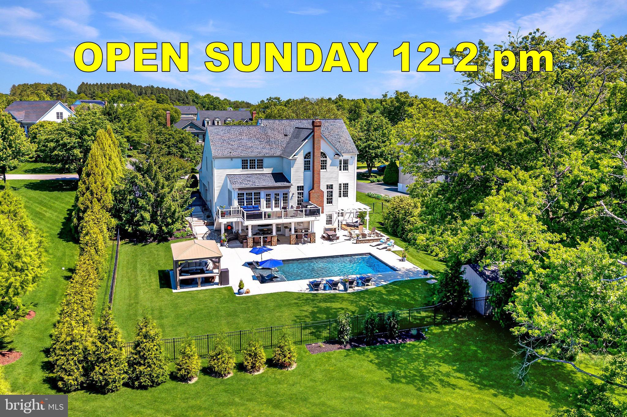 This exceptional brick-front Colonial estate blends timeless elegance with resort-style living, creating an extraordinary retreat where luxury, comfort, and unforgettable entertaining come together seamlessly. Perfectly positioned on a beautifully landscaped 0.46-acre tree-lined homesite, the property offers remarkable privacy while delivering an incredible indoor and outdoor lifestyle. Featuring six bedrooms, five and a half bathrooms, and four finished levels, every space has been thoughtfully designed for both grand entertaining and everyday living.
<br><br>
The curb appeal is undeniable from the moment you arrive, with mature landscaping, manicured gardens, and a stately three-car side-load garage creating a memorable first impression. Beyond the front entry, the backyard transforms into a private outdoor sanctuary designed to feel like a luxury vacation destination. The sparkling pool serves as the centerpiece, surrounded by an expansive sundeck perfect for lounging in the sun. A charming gazebo provides a shaded retreat, while a custom firepit area framed by retaining walls creates the ideal gathering place on cool evenings. Separate grilling and entertaining areas offer endless opportunities for hosting family and friends. The upper-level deck with retractable awning overlooks the beautiful setting below, while the expansive lower patio creates yet another destination for relaxation with granite-topped gathering bars, extensive seating areas, outdoor refrigeration, icemakers, and room for celebrations large and small.
<br><br>
Inside, a dramatic foyer makes a stunning first impression, framed by formal living and dining rooms and enhanced by elegant trim work, detailed moldings, and a sweeping staircase. A private home office with custom built-ins provides the perfect work-from-home environment.
<br><br>
The kitchen serves as the heart of the home and was designed with both beauty and function in mind. Stunning quartz countertops, premium appliances, abundant prep space, and an exceptional walk-in pantry with custom built-ins and tailored organization create a space that is as practical as it is impressive. The adjoining morning room fills with natural light and provides direct access to the rear deck, while the spacious family room is anchored by an impressive stone fireplace.
<br><br>
Upstairs, the luxurious primary suite serves as a private retreat featuring cathedral ceilings, a spa-like bath with soaking tub, dual vanities, and an oversized frameless glass shower. Two expansive walk-in closets with custom built-ins and a dedicated dressing area complete the suite.
<br><br>
The secondary bedrooms are equally well appointed, with one offering a private ensuite bath while two additional bedrooms share a spacious hall bath. An upper-level laundry room adds everyday convenience. The finished attic level offers exceptional flexibility with a bedroom and full bath, creating the perfect teen retreat, guest suite, or private lounge space.
<br><br>
The fully finished lower level elevates the home's entertainment experience even further. A custom built-in bar features a kegerator, beverage refrigerator, dishwasher, and icemaker, creating an impressive hospitality space. A dedicated movie room with projector and screen provides an authentic theater experience, while a spacious game room and exercise room add versatility. The lower level also includes a private bedroom with attached full bath and a second laundry room, making it ideal for guests or extended stays.
<br><br>
Additional major updates provide peace of mind, including a roof replaced with top-of-the-line 50-year wind-resistant shingles, along with recently replaced HVAC systems and water heater.
<br><br>
Perfectly positioned just 0.9 miles from the Metro with immediate access to the Toll Road and moments from Dulles International Airport, this remarkable residence delivers luxury living and exceptional convenience for commuting, travel, and everyday life.