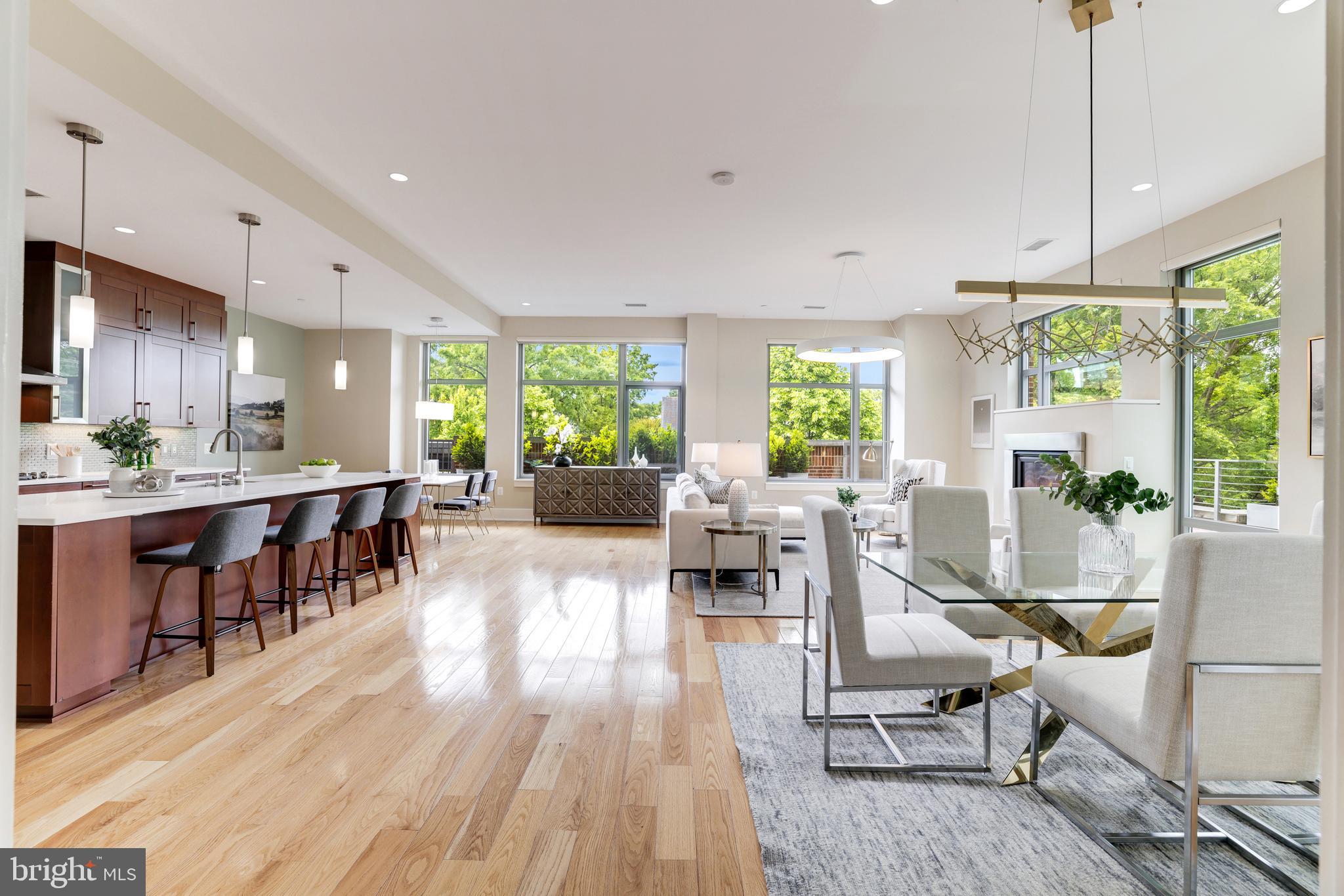Sophisticated and luxurious, this 3 bedroom plus office and 2.5 bath residence is surrounded by mature trees, and special  plants in an L shaped extra large patio.   In this end unit, natural light fills the interior space all day long.  Ceilings throughout are a wonderful 10'9" high.  The open concept floor plan with floor to ceiling windows is dramatic and enhanced by an indoor/outdoor two-sided gas fireplace opening to the patio.   The great room is spacious for entertaining and accommodates a large dining table for enjoying a wonderful meal.  A chef's kitchen offers  top of the line Wolf cooktop, microwave and Subzero refrigeration.  Custom built-ins in the office are carefully designed with a library-type ladder.  The guest rooms and full bath are well appointed and feature additional floor to ceiling windows.  The primary suite offers two custom walk-in closets, a spa-like bath with large marble shower, and a linen closet.  Two parking spaces convey with the property along with a storage room.  Amenities of The Oronoco include 24-hour security and  staffed lobby, heated outdoor pool, fitness and yoga rooms,  meeting room, children's play room, a dog-washing station plus a bicycle storage room.   Enjoy the waterfront park, nearby shopping, great restaurants, the walk-jog-bike trail and close proximity to King Street and all Old Town has to offer.