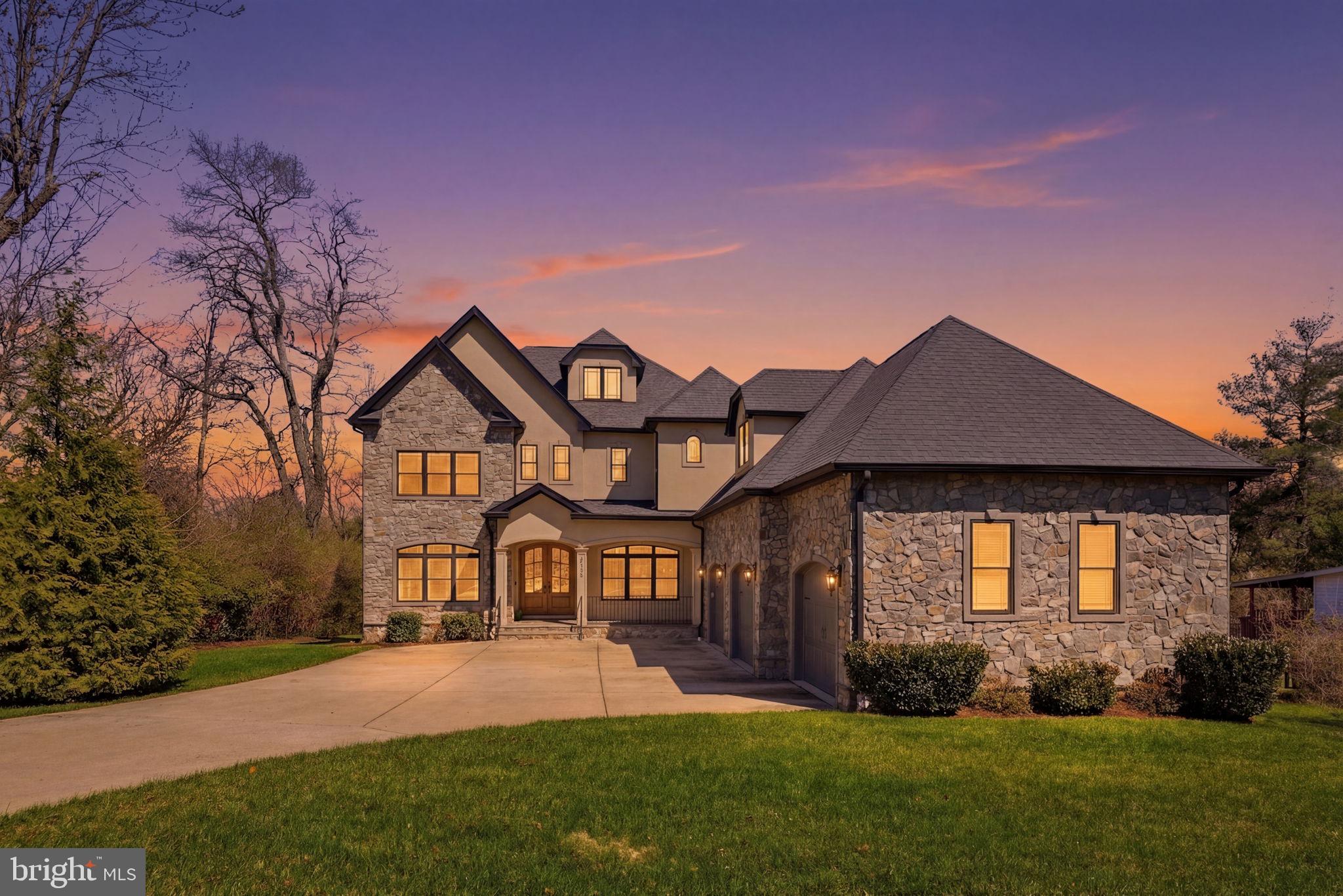 Crafted by a builder with something to prove, this extraordinary custom-built residence was completed in 2018 and thoughtfully designed to embody modern luxury at every turn. Perfectly sited on a private 0.6-acre lot in the heart of Vienna, this home offers luxury living without sacrificing everyday convenience, just moments from top tier schools, parks, shopping, and major commuter routes.
Spanning over 7,200 square feet across four impeccably finished levels, this home makes a striking first impression with its elegant stone and stucco façade, expansive driveway, and welcoming front porch. Bespoke solid wood double entry doors open to a grand light-filled foyer, where sophisticated architectural elements, curated lighting, and a meticulous attention to detail set the tone for each and every space in this home.
The main level is a masterclass in contemporary design, anchored by a stunning family room featuring a sleek two-way wall-mounted gas fireplace, intricate moldings, coffered ceiling and statement lighting. 

Two sets of sliding glass doors open to a three-season sunroom—with skylights and a ceiling fan—creating an inviting environment for year-round entertaining.
At the heart of the home lies a truly exceptional chef’s kitchen, appointed with premium quartz surfaces, a dramatic waterfall island, custom cabinetry with glass accents, and a suite of professional-grade Thermador appliances—including four ovens, dual dishwashers, and a six-burner range with integrated grill. Off the kitchen you will find a spacious walk-in pantry and a practical, thoughtfully designed mudroom. Formal living and dining spaces make for a stately introduction to the home while a private main-level bedroom with a full bath offers ideal flexibility for guests or multigenerational living.
Upstairs, the owner’s suite is a serene retreat, complete with a gracious sitting area, tray ceiling, and fireplace. Dual custom walk-in closets provide tailored organization, while the spa-inspired bath features heated marble floors and an oversized shower with a soaking tub, creating a sanctuary of comfort and indulgence. Additional bedrooms each offer en-suite or adjacent baths and walk-in closets, complemented by rich hardwood flooring throughout. A separate staircase leads to a private suite or executive home office, complete with its own bath and climate control for ultimate versatility. The uppermost level presents a loft-style flexible space with a full bath.  The fully finished lower level is designed for both leisure and wellness, featuring a mirrored fitness studio, an expansive recreation room with fireplace, and a sophisticated wet bar appointed with granite counters and a wine refrigerator. Ample storage and additional bath accommodations further enhance this level which walks out to a beautifully curated flagstone patio. Every detail of this home reflects a commitment to quality and comfort, including an integrated multi-zone climate system, sprinkler system, custom window treatments, designer lighting, and a comprehensive exterior security system. This is a residence that exceeds expectations at every turn—crafted for those who appreciate exceptional living.