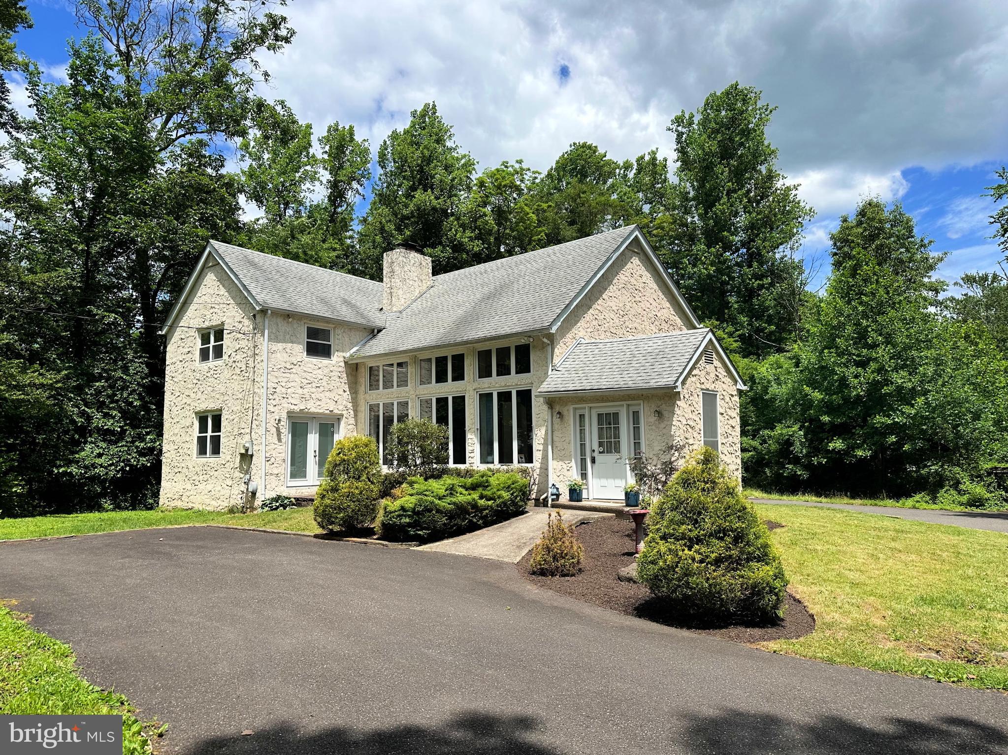 As you travel down the private lane, you'll arrive at your own secluded paradise nestled on more than 18 acres of picturesque land. This two-story home was completely rebuilt in 2011 and offers the perfect blend of modern comfort and peaceful country living. Step into the welcoming foyer and be greeted by a spacious great room featuring a living area and sunroom with a dramatic wall of windows that fills the space with natural light. The vaulted ceiling and impressive stone fireplace with a wood stove insert create a warm and inviting atmosphere. The spacious kitchen offers a bright breakfast area surrounded by windows overlooking the rear yard, making it the perfect place to enjoy your morning coffee. The first floor also features a formal dining room and a convenient powder room. Just off the kitchen, the rear deck provides an ideal setting for outdoor entertaining and relaxation. A beautiful open staircase leads to the second floor, where you'll find the primary bedroom and private bath, along with three additional bedrooms and a full hall bath. The expansive acreage offers endless opportunities for outdoor recreation, gardening, hunting, and more. Adding to its appeal, the lower corner of the property is close to Pennsylvania State Game Lands, providing access to approximately 350 acres of additional land and making this a true hunter's dream. Also located on the property is a mobile home that is currently tenant-occupied and generating income, though it could be removed if desired. There is a 30' x 34' outbuilding great  for storage.  Conveniently located near Route 309 and other major travel routes, this unique property offers privacy, space, and accessibility. Don't miss this rare opportunity to own a one-of-a-kind retreat.