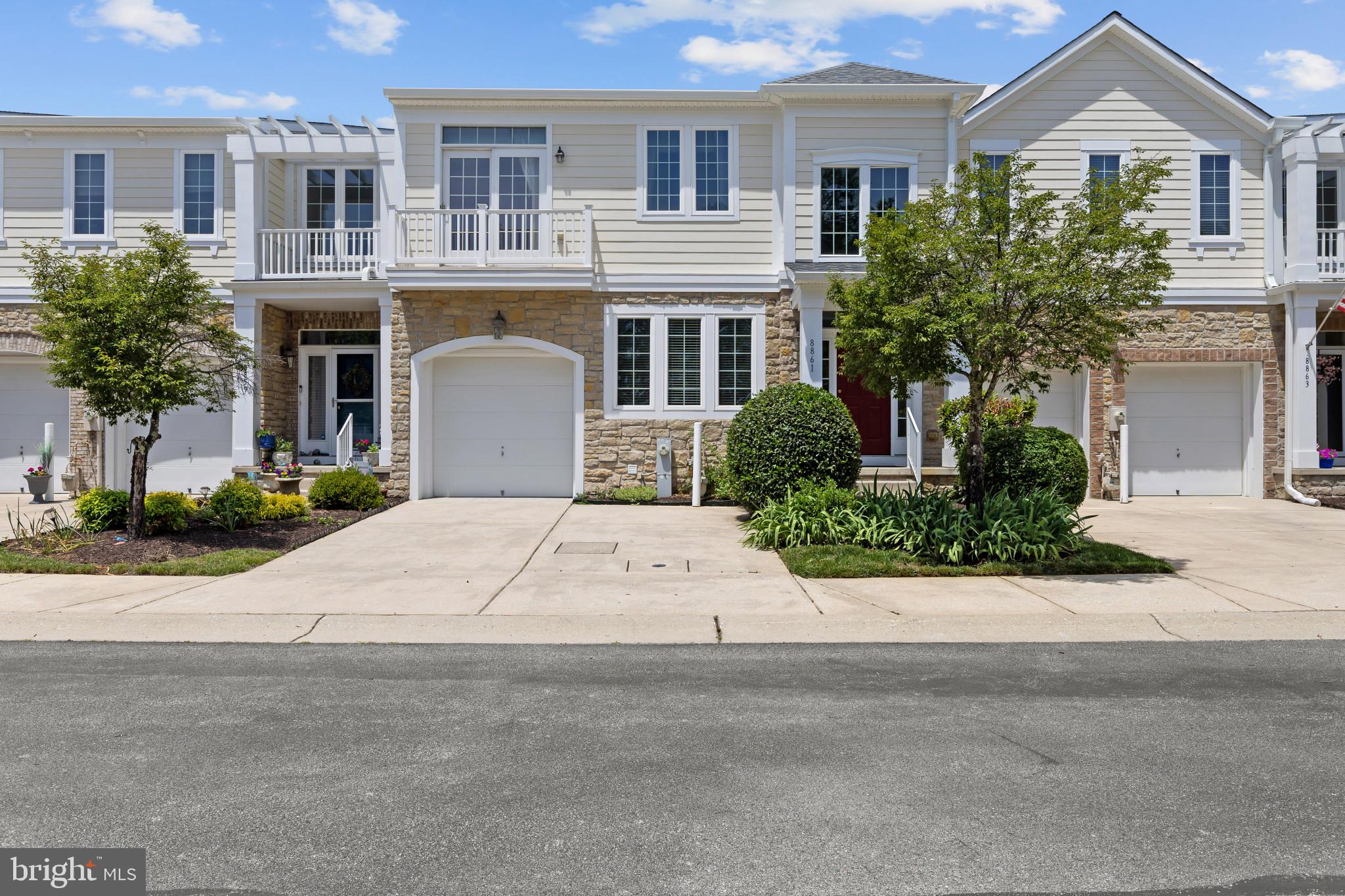 Elegant stone-accented villa-style townhouse residence offering 3 bedrooms, 3.5 bathrooms, 3,940 finished square feet, and a 1-car garage in the amenity-rich 55+ community of Snowden Overlook. // Step inside the main level, where hardwood floors flow throughout a thoughtfully designed layout beginning in the grand foyer. To the left, the formal dining room is enhanced by elegant columns and a convenient wet bar, creating the perfect setting for entertaining. A nearby powder room and laundry room add everyday functionality. // Continue into the expansive open-concept great room, where the beautifully appointed eat-in kitchen serves as the heart of the home. Highlights include granite countertops, an island with breakfast bar seating, a peninsula breakfast bar, a pantry, and updated stainless steel appliances, including a refrigerator and dishwasher replaced in 2025. An adjacent dining area seamlessly connects the space, while the spacious living room impresses with soaring two-story cathedral ceilings, a cozy gas fireplace, and exterior access to a back patio with a privacy wall. // Convenient single-level living continues with the luxurious main-level owner's suite, featuring a private ensuite bath complete with a double-sink vanity, soaking tub, and separate shower. // Newly installed carpeting extends throughout the upper level, which offers a versatile loft overlooking the living room below, two generously sized bedrooms, each with a walk-in closet, and a full bathroom. // The finished walk-up lower level expands the home's versatility with multiple bonus rooms ideal for a home office, hobby room, fitness space, or media room. One bonus room features a walk-in closet and access to a full bathroom, creating an excellent guest suite option. A utility room with a water heater replaced in 2024 provides additional storage and functionality. Additional updates include an HVAC system replaced in 2021. // Residents of Snowden Overlook enjoy an exceptional lifestyle with access to resort-style amenities, including a clubhouse, fitness center, community pool, tennis courts, scenic paths, tot lots and playgrounds, and a nearby golf course with membership opportunities available. Select images have been virtually staged for illustrative purposes.