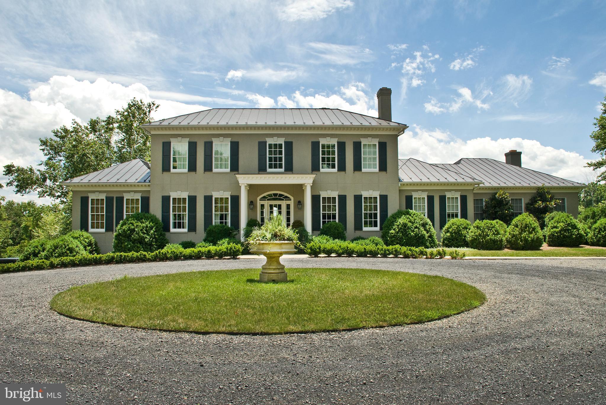 Welcome to Waverly Hill, an elegant Middleburg country estate beautifully situated on 20+ private acres with Goose Creek frontage and mountain views. Custom built in 2002 by University Homes, this Georgian estate offers 8,000+ finished square feet on three levels including 4 bedrooms, 5 full bathrooms, 1 half bathroom, and a 2 car attached garage. The spacious, bright, and airy interior boasts well-appointed finishes, stunning architectural detail, and a thoughtfully designed floor plan perfect for entertaining. The special features include wide ash board floors on the main and upper level, custom built-ins, wainscotting, deep moldings, an eat-in gourmet kitchen, a formal dining room, and a formal sitting room. Relax and unwind in the beautifully designed main floor primary suite with a walk-in closet and a luxury bath with double vanities, a soaking tub, and a standing shower. The upper level offers three bedrooms with en-suite bathrooms. The stately back porch with panoramic views of the mountains and multi-level garden is ideal for your next gathering! Located in Middleburg Hunt territory.
