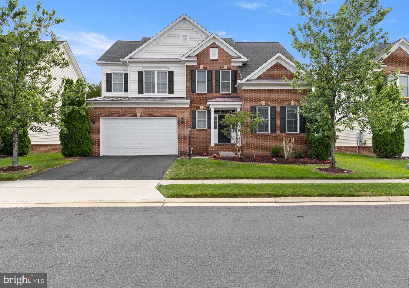 Welcome to an exceptional 5 bedroom, 4.5 bathroom residence in one of Brambleton's most sought-after neighborhoods, where thoughtful upgrades, elegant finishes, and exceptional versatility come together in a beautifully maintained, move-in ready home designed for both everyday comfort and effortless entertaining. 


Beautiful hardwood flooring extends throughout all three finished levels, complemented by fresh paint, updated lighting, custom built-in closet systems in every bedroom, and designer window treatments. The spacious and functional floor plan offers generous living and entertaining spaces filled with natural light, creating a warm and inviting atmosphere throughout.


At the heart of the home, the gourmet kitchen seamlessly connects to the family room and dining areas, providing the ideal setting for everyday living and entertaining. The fully finished lower level adds tremendous flexibility with a second full kitchen, additional bedroom, full bathroom, and expansive recreation space, making it ideal for multi-generational living, long-term guests, an au pair suite, or potential income-producing opportunities. A dedicated media room with built-in surround sound speakers delivers the ultimate movie night experience.


Step outside to enjoy a private backyard retreat backing to open space with no homes directly behind, offering added privacy and peaceful views. The backyard patio provides the perfect place to relax, entertain, or enjoy cool shaded evenings outdoors, while the in-ground sprinkler system helps maintain the beautifully landscaped yard with ease.


Additional premium features include whole-house water filtration, reverse osmosis drinking water system, radon mitigation system, garage storage cabinetry, included washer and dryer, and a desirable brick and siding exterior that offers both curb appeal and lasting quality.


Located within one of Loudoun County's most desirable communities, residents enjoy top-rated schools, extensive amenities, miles of trails, parks, pools, shopping, dining, and the convenience of HOA-covered internet and television service. Meticulously maintained and truly move-in ready, this rare offering combines comfort, functionality, and exceptional value in the heart of Brambleton.