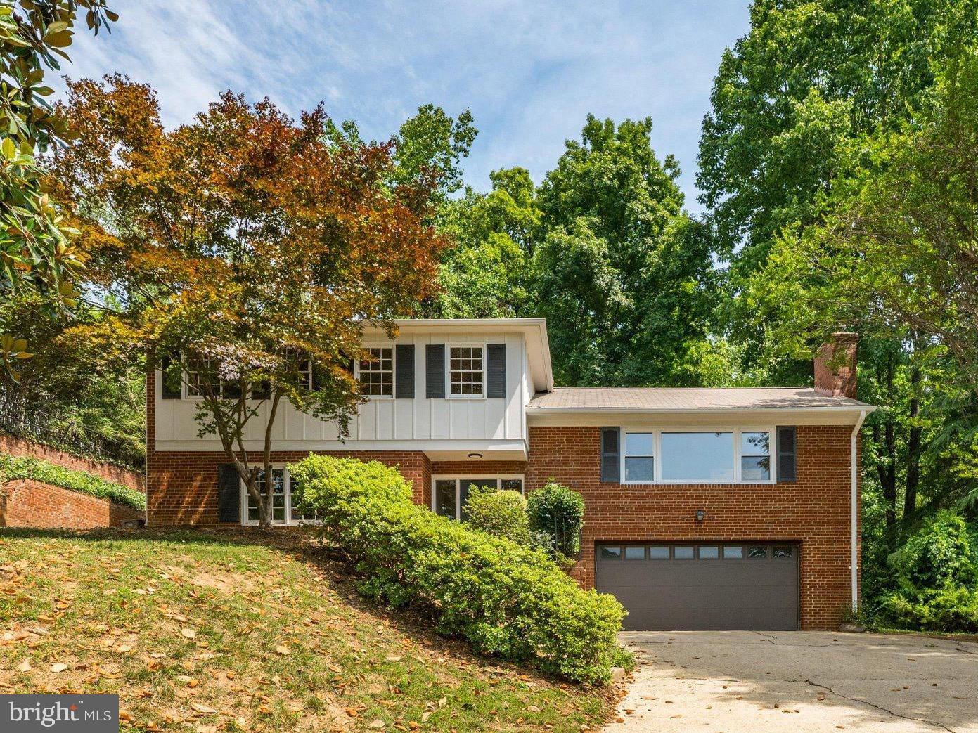 Beautifully reimagined and extensively renovated, this 4-bedroom, 3-bath split-level offers exceptional space, rare premium finishes, and an unbeatable location in one of North Arlington's most coveted neighborhoods — all inside the Beltway with views stretching over the neighborhood and Potomac River valley.

From the moment you arrive, the southern exposure, mature magnolia, red maple, and prolific fruit trees — fig, peach, and apple — create irresistible curb appeal. Inside, nearly 2,800 square feet unfolds across three finished levels, anchored by a gourmet chef's kitchen that would impress even the most discerning buyer. The fully renovated kitchen centers on a professional 48-inch Thermador dual-fuel range and steam oven, with a complementary Thermador hood, built-in bottom-freezer refrigerator, and dishwasher — the complete Thermador suite. White cabinetry, quartz counters, a striking wood-look tile backsplash, skylight, and warm hardwood floors create a kitchen equally suited for weeknight dinners and weekend entertaining.

The home's true showpiece is the stunning glass sunroom addition — a vaulted, light-flooded sanctuary with exposed painted rafters, skylights, floor-to-ceiling windows on three sides, and a French Anderson door opening to the private patio and outdoor gas grill hookup. Whether it's morning coffee or evening gatherings, this space seamlessly brings the outside in. The living room and dining room provide generous formal entertaining space, while two wood-burning fireplaces — one on the main level, one on the lower level — add classic warmth and character throughout.

Both bathrooms were fully renovated​ with designer tile, modern vanities, and contemporary fixtures. The primary bath features marble subway tile and a glass-enclosed shower; the renovated hall bath showcases crisp white subway tile, a soaking tub, and gold hardware accents. 

The lower level features a spacious family room and fourth bedroom or flex space, with all-new flooring replacing dated parquet — part of a comprehensive 2026 interior refresh that includes fresh paint throughout, updated door hardware, and multiple electrical upgrades. The attached two-car garage (27' x 22') provides exceptional parking and workshop space. The transformed backyard features a substantial retaining wall creating a generous level entertaining terrace with raised garden beds — perfect for outdoor movie nights, game days, and al fresco living. Attic insulation, tankless water heater, new HVAC unit (2023), updated sewer injector pump, and new garage door round out nearly $200,000 in documented improvements.
Location is unmatched. Situated in the beloved Waycroft-Woodlawn neighborhood, residents enjoy quick access to Gulf Branch, Potomac Heritage trail​, Georgetown along the canal​, Ballston Quarter, the Custis Trail, Lacey Woods Park, I-66, and the Ballston Metro (Orange and Silver lines). Arlington County Public Schools serve the neighborhood, consistently ranked among Virginia's very best. Easy commutes to DC, Tysons, and the Pentagon make this the ideal inside-the-Beltway address.