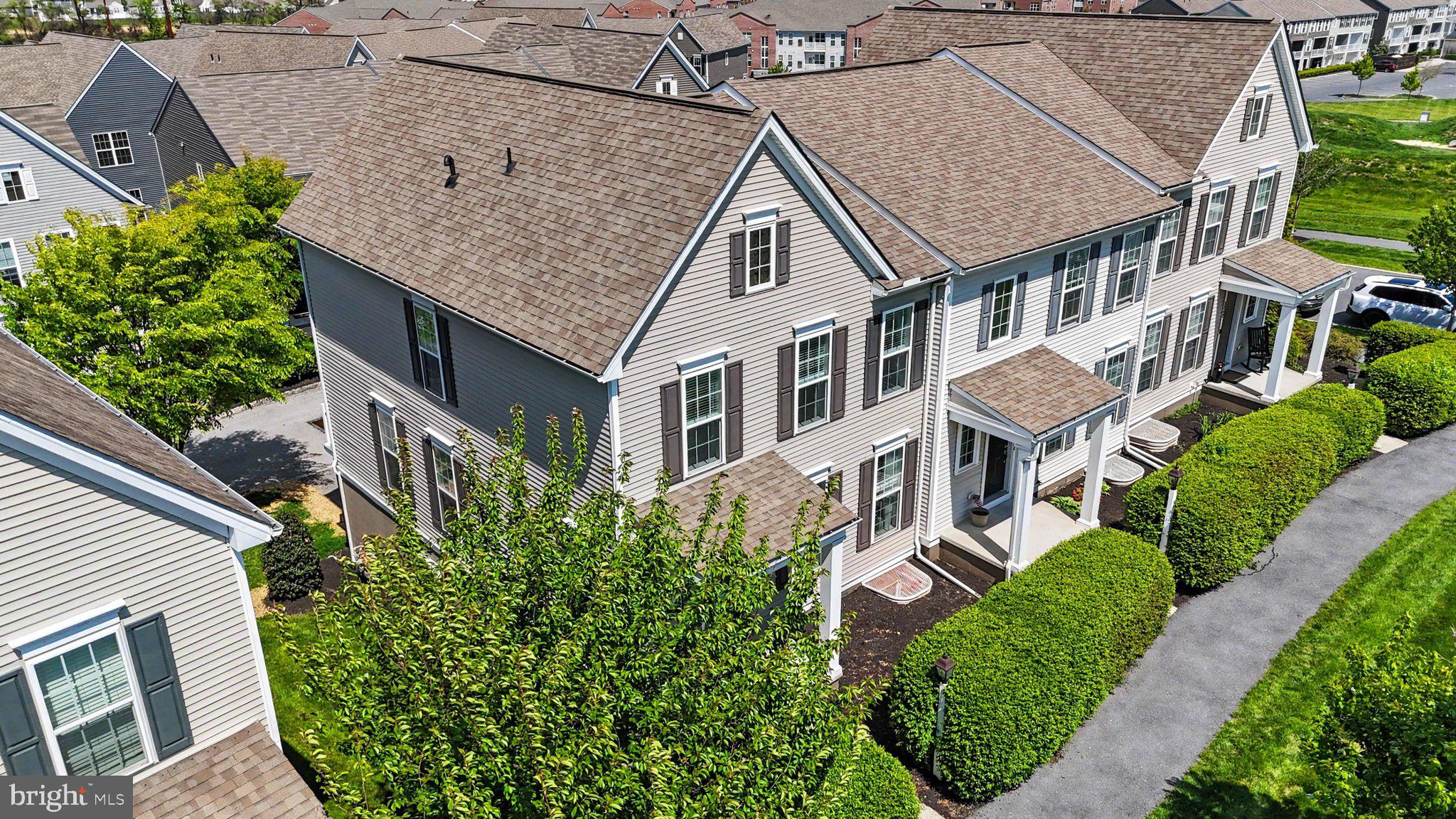 Welcome to luxury living in the highly sought-after Arcona neighborhood with this stunning end-unit Taunton floor plan. Spanning 2,224 square feet across three finished levels, this townhome offers a sophisticated blend of modern design and unmatched "walk-to-everything" convenience on the West Shore.

The heart of the home is the expansive second-floor Great Room, where oversized windows—exclusive to an end-unit—flood the open-concept layout with natural light. Beautiful wood flooring and recessed lighting flow throughout the main level into the gourmet kitchen. This chef-inspired space is fully equipped with premium granite countertops, classic white maple cabinetry, a large center island, a walk-in pantry, and a spacious dining area perfect for entertaining.

The third floor serves as a quiet retreat, featuring plush carpeting throughout. The primary owner’s suite is a true sanctuary, boasting a luxury full bath and a generous walk-in closet. Two additional well-appointed bedrooms share access to a full guest bath and a conveniently located laundry space, making daily chores a breeze.

The lower level provides incredible flexibility to suit your lifestyle needs. Currently configured as a private theatre room, this finished space includes additional storage and can easily transition into a fourth bedroom or a professional home office. Beyond the two-car garage, you are just steps away from the vibrant Arcona lifestyle. Enjoy immediate access to local dining, boutique shops, fitness centers, and miles of scenic walking trails that lead you to where life is lived and memories are made. Schedule your tour today to experience the very best of West Shore townhome living.