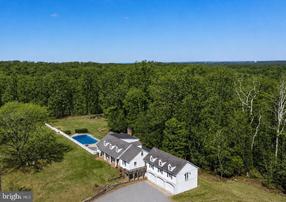 Some Places Witness History. Others Become Part of It. 
As America celebrates its 250th Anniversary, few properties offer the chance to own a tangible connection to the past. Nestled along one of Maryland's most historic corridors, 1116 & 1118 Gumbottom Road encompasses nearly 45 acres of history, legend, and possibility. Once a farm and steeped in local lore with ties to Maryland's colonial and Revolutionary-era heritage, this is more than a home—it's a rare opportunity to become part of the American story.
Set on a quiet no-through road, the property includes approximately 40 acres plus a separate 5-acre parcel with a 1997 perc test on file (county approval required; buyers to verify). Whether envisioned as a private estate, equestrian retreat, homestead/hobby farm, or multi-generational compound, the possibilities are as expansive as the landscape itself.

Rolling pastures, mature trees, ATV trails, and multiple outbuildings—including a barn and former horse corral—create a setting that feels worlds away, yet remains convenient to Annapolis, Baltimore, Washington, D.C., golf courses, marinas, dining, and shopping.

The thoughtfully updated farmhouse blends modern comfort with timeless character. Recent improvements include updates to the roof, barn, electrical and plumbing systems, flooring, paint, and bathrooms, preserving the home's charm while making it move-in ready. Inside, six bedrooms and six bathrooms offer exceptional flexibility. The heart of the home is a welcoming kitchen with quartz countertops that opens to a warm family room with exposed beams and a fireplace. A formal dining room, sun-filled office/parlor overlooking magnolia trees, and a main-level primary suite with private entrance, ensuite bath, and sweeping pasture views complete the first floor.

Upstairs, three additional bedrooms include a private ensuite and two connected by a charming secret passageway, along with a beautifully renovated full bath.

The lower level features a spacious recreation room, workshop, half bath, and direct access to the three-car garage.

Outdoors, the lifestyle opportunities are endless. Explore wooded trails, gather around the secluded campsite and fire pit, practice your golf swing, relax by the pool, or simply enjoy the peace and privacy of your own historic countryside retreat.

Rarely does a property offer this combination of acreage, character, history, and future potential. More than a home, this is a legacy property—one that has witnessed generations of Maryland history and is ready for its next chapter.

Sale includes the separate 5-acre parcel known as 1118 Gumbottom Road. A perc test was completed in 1997; buyers are responsible for independently verifying all development potential with Anne Arundel County.

Conveniently located near golf courses, dining, shopping, and boating, this is more than a home—it’s a rare opportunity to enjoy a turnkey property with room to grow. Sale includes the 5-acre parcel known as 1118 Gumbottom Rd.(a previous perc was done in 1997).*Per the county, buyers must verify independently. Agents please see remarks.