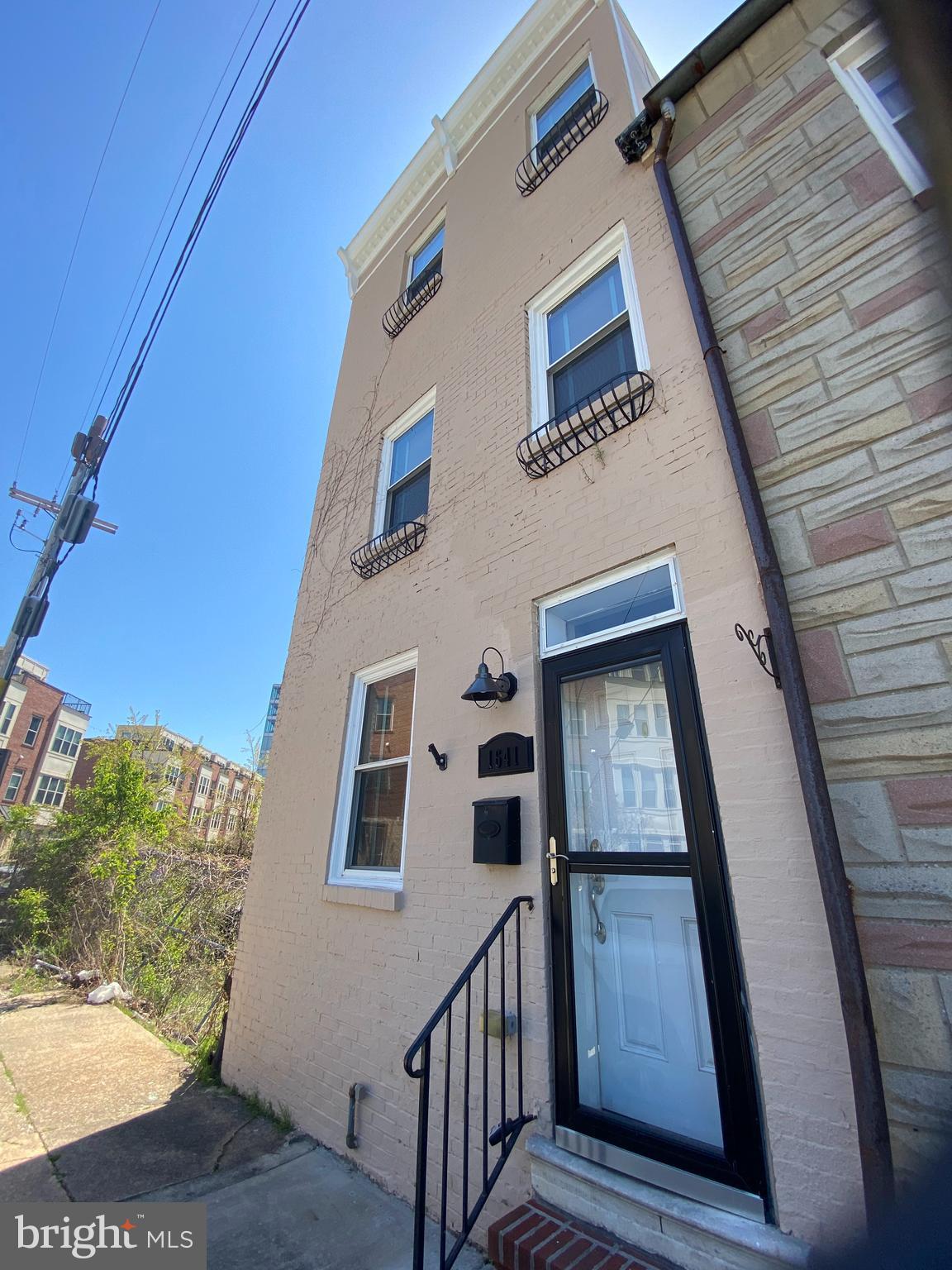Wonderful 3 bedroom, 2.5 bath renovated rowhome with PARKING and ROOFTOP DECK with WATER VIEWS! Make this your new DREAM HOME NOW! Features wood floors, open layout, rear patio and parking pad, 2nd floor boast 2 bedrooms, 1 full bath, laundry room and 3rd floor has master suite with walk in closet, master bathroom with dual vanities, tub and stand up shower and wet bar leading to read deck to spiral staircase to ROOFTOP DECK! Start enjoying the CITY LIFE! Available  NOW! Pictures are from 2 years ago.