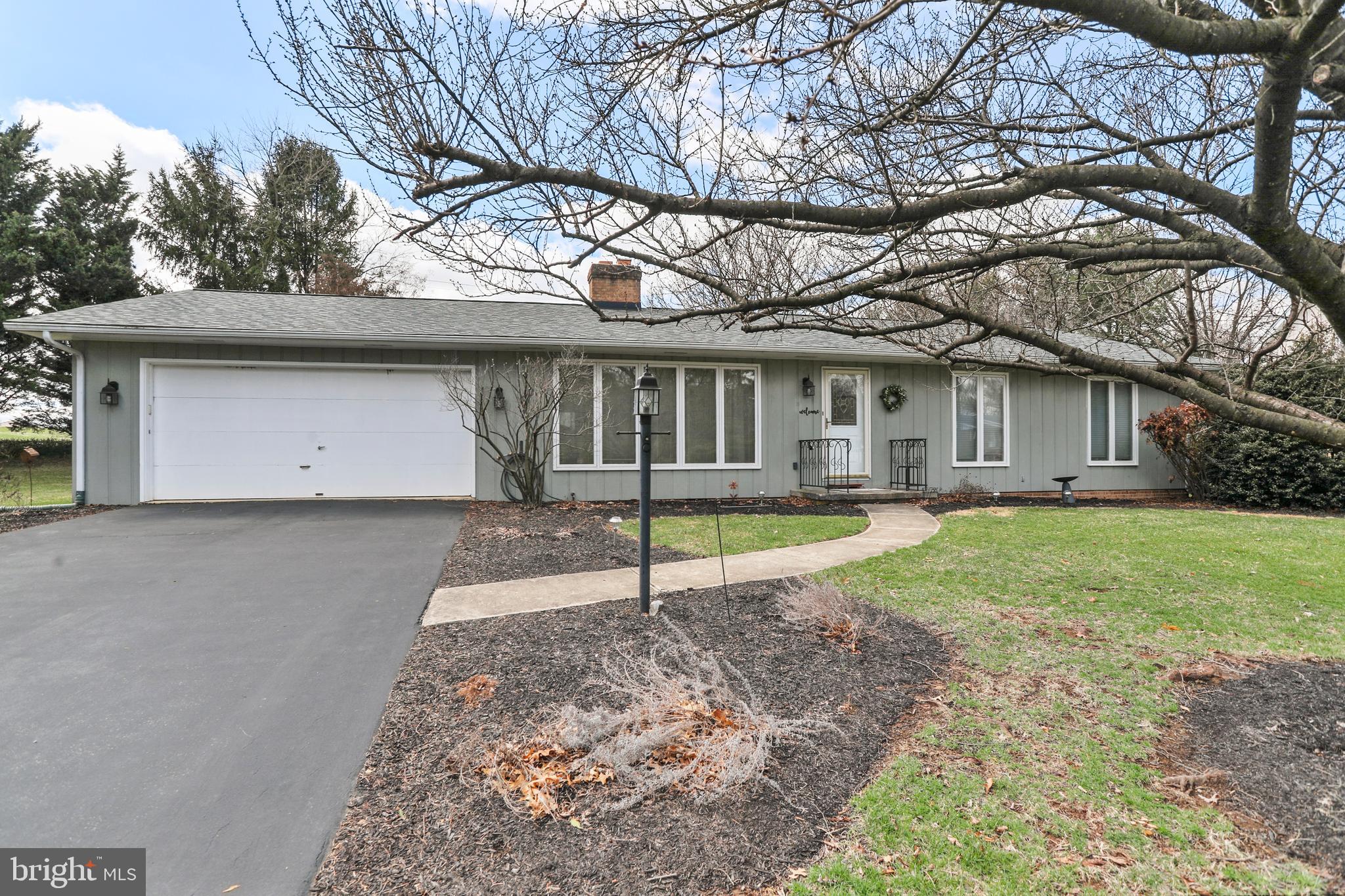 Welcome to this delightful 3-bedroom 2-bath rancher, perfectly situated on a spacious 0.46-acre corner lot! Featuring 1,421 sq.ft. of living space. As you step inside, you're greeted by beautiful hardwood flooring that flows throughout the home. The spacious living room is centered around a cozy wood-burning fireplace, perfect for relaxing evenings. The eat-in kitchen features white cabinetry, vinyl flooring, and all appliances, making it a functional and inviting space for meal prep and family gatherings. The primary bedroom offers a private en-suite with a walk-in shower. Two additional bedrooms share an updated hallway bathroom, which was updated just two years ago. A convenient laundry closet adds to the home's practical layout. Whether it's a sunny morning or a cool evening, the  bright and airy 3-season room connects you to the outdoors in comfort. Brand new roof installed in 2024, peace of mind for years to come. The sizable lot gives you plenty of room to enjoy the outdoors, whether you're gardening, entertaining, or simply unwinding. This home offers a serene atmosphere, while still being conveniently close to local amenities. Don't miss the opportunity to call this your new home!