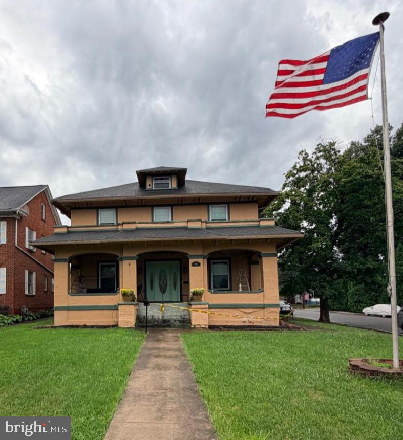 Step into the timeless charm of this stunning Craftsman-inspired American Foursquare, built in 1902, where historic character meets thoughtful modern updates. Offering over 3,200 square feet, 5 bedrooms, 3 full bathrooms, and an abundance of original craftsmanship, this architectural gem is ready for its next chapter.

The heart of the home is the beautifully renovated chef's kitchen, featuring a gas range, abundant cabinetry, and plenty of workspace. The main level also offers two spacious living rooms, a formal dining room, a renovated full bathroom with laundry/mudroom, a bedroom which could also function as an office, and exceptional storage throughout. Upstairs, you'll find four bedrooms, a storage room, a balcony, and two more full bathrooms. 

The opportunities continue with a full unfinished attic that could be transformed into additional living or storage space, along with an unfinished basement providing even more storage. Outside, enjoy a fenced backyard, a detached two-car garage, and a storage shed. You will have plenty of room for whatever your heart desires. 

Major improvements already completed include a renovated kitchen, updated bathroom/laundry room, updated upstairs hall bathroom, newer roof (2017), newer hot water heater (2024), a new sump pump, and the addition of the detached garage and storage shed.

Like many homes of this era, this property still has room for improvement. The front porch foundation requires repair, and the upstairs HVAC system is currently not functioning and utilizes window AC units. With these items addressed and continued restoration, this remarkable home has the potential to be returned to its original grandeur while preserving its rich architectural heritage.

Whether you're an investor searching for a standout restoration project or a buyer looking for a one-of-a-kind family home with space, character, and history, this is an opportunity that doesn't come along often. Homes of this size, quality, and architectural significance are increasingly rare.

Bring your vision and breathe new life into one of Martinsburg's historic treasures. This extraordinary home offers the chance to own a true piece of history while building equity through thoughtful restoration.