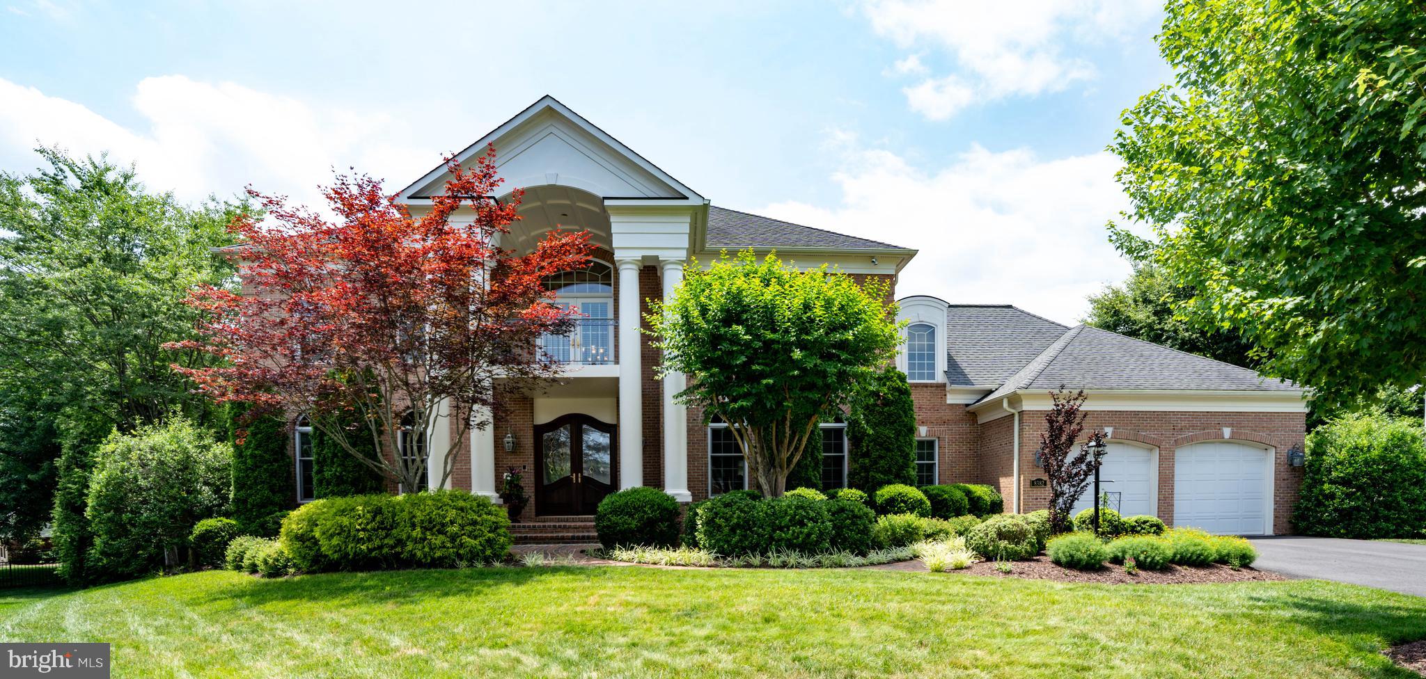 Welcome to an extraordinary residence located in the prestigious Gated Golf Course Community of Lake Manassas. Offering unrivaled distinction, this home boasts a signature Entre’s builder design not replicated anywhere else in the subdivision. Nested on a quiet cul-de-sac, this custom full-brick estate offers over 6,000 finished square feet of exceptional living space. From the impeccable craftsmanship and thoughtful design throughout – highlighted by extensive millwork, graceful arched openings, solid oak hardwood flooring spanning the main and upper levels, 9-foot ceilings on all three floors - to the lush mature landscaping, manicured garden and resort-style backyard, this home delivers on every promise. Upon entering, the grand two-story foyer greets you with a soaring backlit barrel-vaulted coffered ceiling, an elegant chandelier, and luminous Spanish marble floors, setting the tone for this incredible residence. Formal entertaining spaces enhanced by striking Palladian-style windows and intricate molding. The gourmet kitchen is a chef’s dream, appointed with custom Decora cabinetry, granite countertops, high-end Wolf and Sub-Zero appliances, two pantries, and a bright breakfast area opening to a private deck overlooking the backyard. A stone fireplace connects the kitchen to the sunken family room featuring a dramatic bow window bump-out that extends through all three levels. A richly appointed oﬃce features a bay window, a cozy gas-log fireplace, and custom-built-in oak shelving. Upstairs, the luxurious owner’s suite offers a trey ceiling accented with backlit molding, two custom closets with built-in organizers, and a spa-like bath with Spanish tile flooring, a jetted Kohler tub, dual-head walk-in shower, and granite dual vanities. Three additional spacious bedrooms include one with a private en-suite bath and two connected by a Jack-and-Jill bath. The finished walkout basement features a spacious billiards area, a custom wet bar, and a large, versatile room perfect for a fifth bedroom or home gym. Enjoy hot summer days in the private outdoor oasis, anchored by a heated Gunite saltwater pool with a built-in spa and waterfall, surrounded by mature arborvitaes to provide exceptional privacy. Car enthusiasts will appreciate the oversized garage with 11-foot ceiling and room for four vehicles. Additional highlights include upgraded lighting, Andersen Eagle E series casement and double-hung windows, completely remodeled laundry room and basement wet bar (2022), 6 car driveway asphalt repaved (2024), ASKO dishwasher (2020), and newer 75 gallon hot water tank (2018). Residents of Lake Manassas enjoy miles of walking and biking trails, an Olympic-sized swimming pool, tennis, pickleball, and basketball courts, a tot lot playground, and two championship golf courses – all within walking distance to Wegmans, stores, and restaurants within The Shops at Stonewall. Convenient to Routes 29 and 15, I-66, the VRE, and within 40 miles of Washington, D.C. and 25 miles of Dulles airport. Top-rated Prince William County Public Schools round out this remarkable offering.