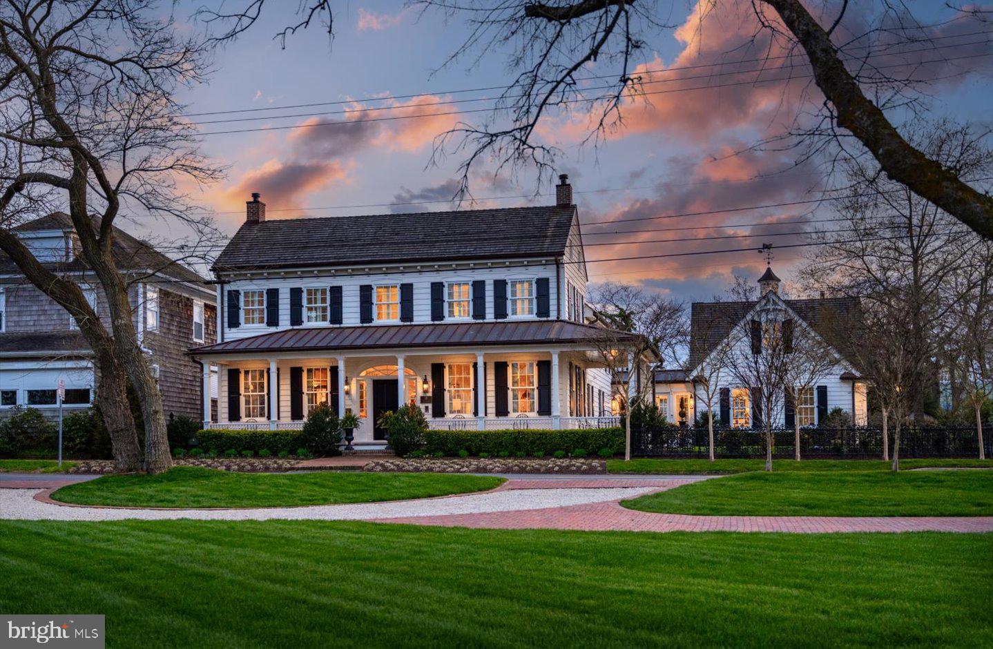Introducing 114 Gills Neck Road, an iconic Lewes home believed to date back to the early 1700’s and a true historic gem. This home has recently undergone almost 3 years of complex renovations by some of the region’s finest craftsman each working to carefully reconstruct a space that feels modern and luxurious while restoring the home’s exquisite historic detail. Situated on almost .7 acres, this canal front home is just steps from the array of popular boutiques and restaurants of downtown Lewes. Pristine landscaping, Victorian period cast-iron fencing, Bevelo copper lights, and a wrap-around front porch all contribute to the excellent curb appeal. Upon entry, you will be in awe by the exquisite architectural detail. A unique barrel ceiling, exquisite moldings, mahogany hand-carved railings, and beautiful flooring are just some of the striking details that masterfully blend modern and historic charm. The library is situated in one of the original sections of the home. The delicate coffered ceiling is finished with gold foil and decorated with a Fortvny, hand painted, silk chandelier both casting a unique glow. An antique English mantel frames the fireplace and is surrounded by custom built-in bookcases, while oversized windows offer breathtaking views of the canal. The adjacent parlor also features oversized windows with stunning views, an intricate coffered ceiling and the original brick chimney that was carefully excavated from multiple layers of plaster. This room opens to the gourmet, chef inspired kitchen with expansive marble counters, copper pendant lighting, and a one-of-a-kind backsplash inclusive of an antique French fire plate and hand selected Dutch tiles from the 1500's and 1600's, above the custom La Cornue range. The kitchen offers unique banquette seating for more casual dining. Neighboring the kitchen, you will find an intimate formal dining area featuring wood beams salvaged from the original structure. The focal point of the dining area is the impressive, temperature-controlled wine-room. Bricks from the home’s foundation were repurposed for the ceiling while salvaged beams were hand carved to create the racking system. The rear of the home offers a more casual living area, complete with a gas fireplace decorated with Austin Stone, a limestone found in quarries throughout Texas. This room leads to a spectacular three season room complete with a wood burning fireplace, heated blue stone floors, and a retractable vinyl screening system. The porch overlooks the enchanting and private rear yard, complete with a brick patio, peaceful fountains, birdbaths and even a fig grove. This is the ideal location for summer relaxation and garden parties. Circling back to the interior, a beautiful glass breezeway will lead you to the oversized 2-car garage and staircase leading to the private guest suite. This private space includes a vaulted ceiling, custom built-ins, sitting area featuring a wood burning stove and a private, en-suite bath. The main house offers dual staircases to the 2nd level where you will find the primary suite and two additional guest bedrooms, each with luxurious en-suite baths. The primary suite offers captivating views, overlooking the canal and wetlands, a spa-style bath, and a spectacular walk-in closet. Aside from superb interior living and peaceful outdoor living, this property is a boater’s dream complete with a newly built, private, deep-water dock and boat lift. The separate, detached garage on the canal side is ideal for all your outdoor toys. This area also provides additional private parking, fire pit, and a space to relax and watch the boating traffic. This home has too many features to list and will not disappoint any buyer.