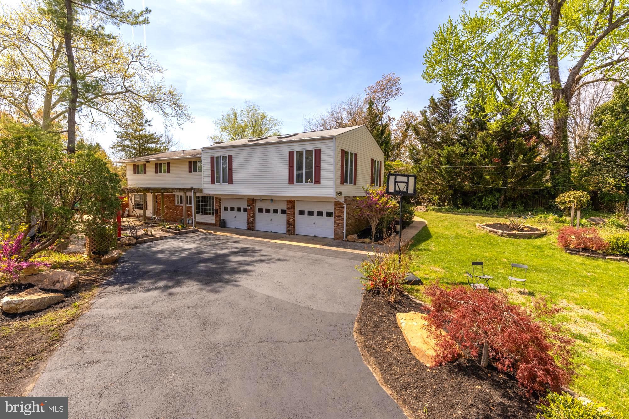 A true garden oasis—custom landscaped and designed to impress. This 4-bedroom, 3.5-bath split foyer is packed with character, featuring floor-to-ceiling windows, exposed brick, skylights, and rich hardwood floors throughout.

The backyard is a showpiece, with beautifully curated landscaping that creates a private, serene retreat—perfect for relaxing or entertaining.

Inside, the kitchen offers granite countertops, cherry wood cabinetry, stainless steel appliances, and a cozy eat-in nook with tranquil garden views.

The sunroom steals the show with its warm wood ceiling, accent wall, skylights, and walls of glass—blurring the line between indoor and outdoor living.

The primary suite features vaulted ceilings, a skylight, and an updated en-suite, while additional bedrooms are spacious with ample storage.

Rare bonus: a three-car garage! A standout feature offering exceptional space for vehicles, storage, or hobbies.

See our attached Property Highlights Sheet for a list of updates.