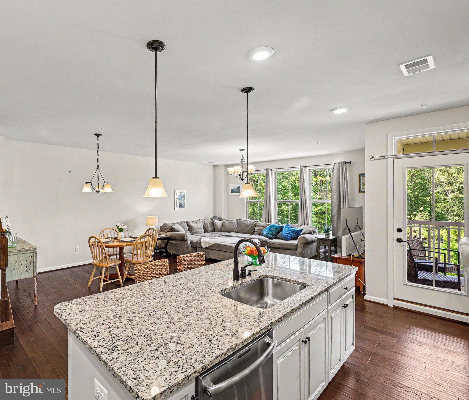 Premier end-unit, top-level townhome—one of the best-located homes in Loudoun Crossing. Overlooking trees rather than neighboring townhomes, this home offers a rare combination of privacy, end-unit living, and an open setting not often found in similar models. Extra windows bring in abundant natural light, while the quiet street setting is just steps from the playground. Enjoy sunset views over a peaceful, tree-lined setting from the balcony off the kitchen, with sunrise views from the front of the home. Exceptional value for a rare end-unit in one of the community's most desirable locations.

Over 2,600 sq ft with 3 bedrooms and 2.5 baths, featuring an open layout ideal for everyday living and entertaining. Gourmet upgraded kitchen with granite counters, painted wood cabinetry with abundant storage, soft-close and pull-out drawers, stainless steel appliances, and an oversized 9' x 4' center island with bar seating. Spacious primary suite with tray ceiling, two walk-in closets, and en suite bath with double vanities and a private toilet. Upper-level laundry with newer high-end appliances. Garage and driveway plus plenty of free guest parking conveniently located behind the home.

Community amenities include clubhouse, pool, tennis courts, fitness center, and walking trails. Excellent Loudoun County public schools within a short 5-minute commute. Just 3 miles from a new 2025 retail center with major stores including Walmart, with additional shopping and dining continuing to expand within a 5-mile radius.  About 15 minutes to Dulles Airport and convenient to Middleburg, Haymarket, Leesburg, and all areas of Northern Virginia.