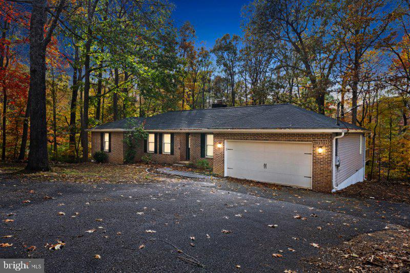 Welcome to 315 Lower Clubhouse Dr. in Harpers Ferry — a fully renovated, move-in-ready brick rancher that brings modern farmhouse warmth and all the big-ticket updates you want already done. This home has been overhauled from the ground up, including a brand-new roof and gutters, a fully encapsulated crawl space with a commercial-grade dehumidifier, new insulation, and an all-new HVAC system with new ductwork. Inside, you’ll find fresh LVP flooring, updated recessed lighting, and a comfortable family room anchored by a wood-burning fireplace. The kitchen delivers serious “wow” factor with quartz counters, a bold 7-ft navy island, new soft-close cabinetry, ceramic tile backsplash, and all-new stainless steel appliances. Both bathrooms have been completely redesigned with modern finishes — including a luxury walk-in tile shower with frameless glass in the primary suite. Every bedroom has updated lighting and new ceiling fans, and even the front door, deck door, and garage entry door are brand new. Step outside to a resurfaced approx. 36’x12’ deck with new railing, plus a spacious 2-car garage and storage shed. With no HOA, low taxes, and quick access to MD and VA, you’re minutes from Mountain Lake Club & Beach, River Country Store, Shannondale Springs Trails, Mount Mission Park, and historic Downtown Harpers Ferry. This is the turn-key home buyers wait for. Come and take a look!