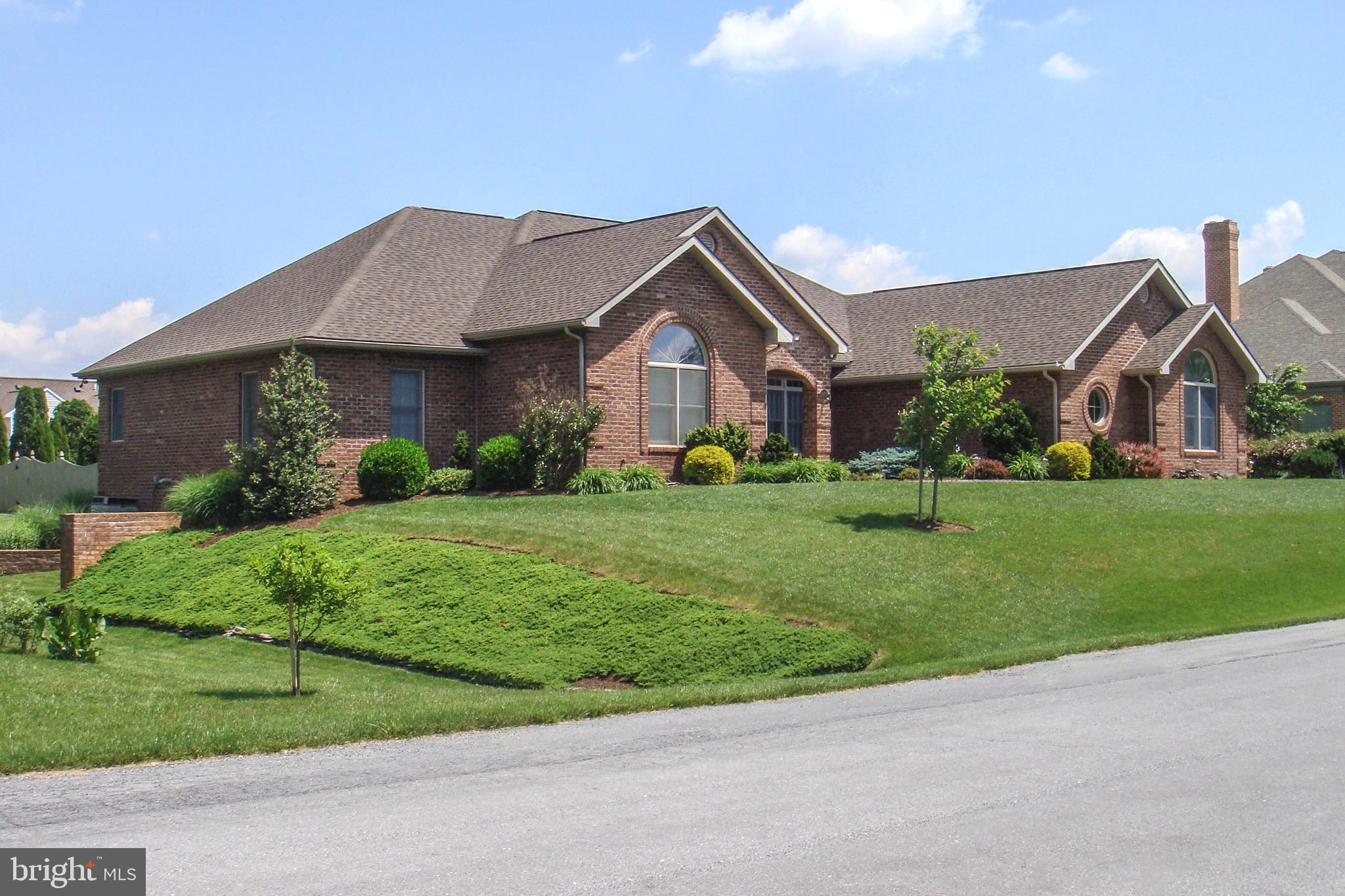 Beautiful brick rancher in highly desirable Fountainhead near the clubhouse, golfing and inground pool.  Fountainhead is one of the most desirable subdivisions in the Hagerstown area and is in the North End where there are mature trees & beauty everywhere you look. This is a one-owner home custom built in 2002 and is not on a thru street. It is an extremely rare huge rancher with 2850 SF on the main level and 1100 SF finished in the basement leaving an additional 2000 SF unfinished to add more finished living area or for your wood shop, hobby shop or mechanic area. Egress to the outside is through 6' doors and only (4) very wide concrete steps. All windows are double-hung top of the line Anderson tilt-windows. The finished area in the basement contains a full bath and lots of built-in storage areas. Many of the wood shop  equipment, parts, tools & wood can be negotiated outside of the sale. There is a 2-car garage and an oversized driveway.
As you enter the front foyer of the home you find 9' ceilings throughout and the drywall corners  have the rare rounded corners. The majority of the rooms on the main level have actual 3/4" hardwood flooring and the house was engineered to make it handicapped accessible with 42" hallways and 36" doors. The home was also engineered  such that the attic could have future rooms  just by adding a staircase. The kitchen is large and contains Corian counters, full extension dove-tailed Kraftmaid cabinets, an island containing room for (4) bar stools, a double oven range with the ovens being electric and the burners are natural gas just like the furnace. There is a trash compactor and a several month old refrigerator with ice and water in the door. The flooring is real hardwood (finished on site). Off the kitchen is the sunroom featuring laminate flooring, a gas fireplace and french doors to the large screened porch with skylights and Stampcrete concrete flooring plus a ceiling fan. The entire home is an open concept, continuing from the kitchen you have a nice half-bath and then the formal living room again with hardwood flooring. There is also a dining room area off the kitchen.  There are french patio doors leading from both the living room and dining room to the screened porch. Between the kitchen and garage entrance is a nice large laundry a laundry sink and a pantry.  There are also built-in cabinets and a large storage closet.  The hall to the bedroom area of the home contains a large coat closet and a linen closet. A full bath in the hall is next to two of the bedrooms one of which has a vaulted ceiling and a circular window and is presently used as a craft room but does have a huge closet. Leaving that bedroom you pass the 2nd bedroom and then onto the large primary bedroom that has a french door leading to the rear patio area. The primary bedroom adjoins the primary bathroom which is quite large and contains a corner jetted soaking tub, large double-sinks with vanity area for a makeup chair.  The vanity has many storage drawers/doors The walk-in shower is oversized with a built-in seat. There are two ample walk-in closets off the bathroom. The Den/office is large and has wall-to-wall cabinets and storage and  built-in file cabinets. There are two desks & additional desk space. The lawn has a sprinkler system and the rear yard is fenced and very private. The roof is only 18 months old & is a 50-year architectural roof. High speed internet is fiber optic. The water heater is only a few years old as is the central air. There is a pond near the screened porch. There is 400 amp 120/240  electric & there is a booster pump on the city water boosting to 80 lbs. There is R-50 insulation in the attic with two sets of pull-down steps. Outside video monitoring. The home is 5 minutes to grocery stores, restaurants, pharmacies, I-81 and I-70, ice cream shop, machanics, schools, etc. Some furniture could be sold outside of settlement. The owner's spouse is a licensed realtor. Call for your tour today.