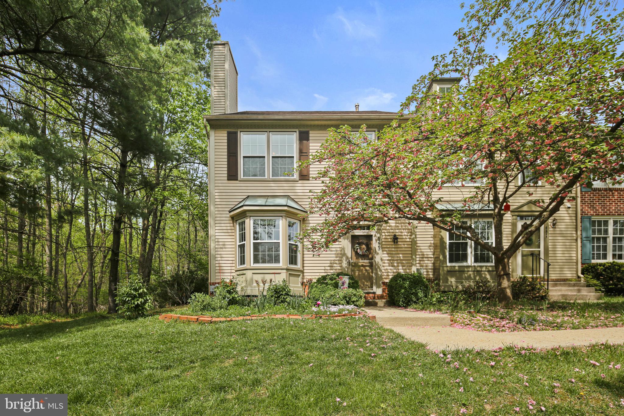 Tucked into the peaceful Willowood community, this beautifully maintained end-unit townhome offers rare privacy with serene wooded views on three sides. Bordered by open community land and adjacent to protected county greenspace, the setting feels like a secluded nature retreat—while still being just minutes from everything you need. Extensive landscaping surrounds the home, creating a natural sanctuary that feels far from the bustle — yet remains close to everything.
Step inside to warm Brazilian cherry hardwood floors and an inviting wood-burning fireplace (gas hookup available).  A charming bay window floods the space with natural light. An expansive dining area also offers panoramic views of the surrounding trees.
The kitchen boasts glass-front oak cabinetry with sleek stainless steel hardware, Silestone countertops, a custom tile backsplash, and a gas range. A glass slider, off the large eat in area, leads to the expansive deck, surrounded by lush gardens and mature trees. An open staircase anchors the home’s three levels, adding architectural interest and flow. 
Upstairs, the vaulted ceilings create a light, airy feel. The spacious primary suite boasts a walk-in closet, double-sink vanity and a luxurious walk-in shower. All bathrooms have been tastefully upgraded, including both full bathrooms which feature the floors and shower designed with marble style ceramic tile, custom navy vanities with quartz countertops. All adorned with stylish mirrors and lighting. Three closets throughout the home are lined in cedar for added luxury and function. 
The open staircase leads to a finished basement with a large laundry and multiple storage areas. New carpet and fresh paint throughout offer a move-in ready experience. A rain barrel system is connected to the roof with a clever overflow design that drains directly into the woods — ideal for eco-conscious watering of flowers and plantings. Additional upgrades include custom cordless shades, a new washer, whole house humidifier, new windows and doors, and roof replaced in 2016. This rare end-unit townhome is a perfect blend of comfort, style, and nature with $133K in upgrades! - a true retreat!
