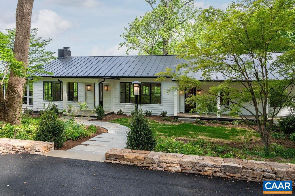 Completely renovated like-new contemporary home in the highly desired neighborhood of Bellair! This home has just been entirely remodeled & finished and is ready for occupancy! Main level features an open floor plan, surrounded by large windows to take in the beautiful pastoral setting, including views of the community pond, Birdwood Golf Course, Boars Head Inn, and all the way to the Blue Ridge Mountains. There are 4 total bedrooms - primary on the main level, 3.5 sparkling-new bathrooms, and a great room with vaulted beamed ceiling soaring to 16 feet. Superb construction, use of quality materials, and exquisite finish details are trademarks of Master Builder, Baird Snyder. Other features include a generous screened porch off the great room (with fireplace) to enjoy the superb natural setting and views from this elevated 5.46 acre homesite. There is a large open yard, wooded areas and a creek, plus a community pond just across Old Farm Road. The residence is surrounded by lovely gardens and plantings, stone hardscape, and numerous large trees.  Inside are great contemporary living spaces with plenty of cabinetry and a magnificent gourmet kitchen for cooking and entertaining!,Painted Cabinets,Soapstone Counter,White Cabinets,Wood Cabinets,Exterior Fireplace,Fireplace in Great Room
