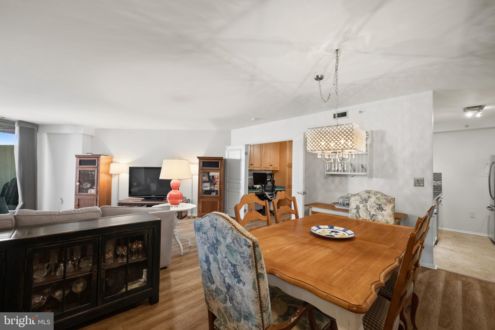 Just steps from Bethesda Row, Metro, dining, and shopping, this beautifully maintained one-bedroom + den at Crescent Plaza Condominium offers an effortless downtown lifestyle. Complete with an assigned garage parking space, this condo combines comfort, convenience, and walkable access to everything that makes Bethesda one of the nation’s most desirable communities.

This bright and spacious 946 +/- square foot layout features an open living and dining area with hardwood floors, sliding glass doors, and a private balcony with sweeping city views. The kitchen is fully equipped with granite countertops, stainless steel appliances, a gas range, and ample cabinet space. The separate office / den provides extra storage and flexible work-from-home space.

The generously sized bedroom includes a walk-in closet, while the full bath makes your morning routine easy-peasy! The in-unit stackable washer and dryer oozes convenience.

7111 Woodmont Avenue #709 is moments from premier shopping, dining, and recreation at Bethesda Row, the Capital Crescent Trail, and the Bethesda Metro station. Residents of Crescent Plaza enjoy exceptional amenities, including a fitness center, elevator access, a pet-friendly policy, and beautifully renovated common areas featuring a grand lobby, hallways, and library.

Move-in ready and filled with potential to make it your own, this rare offering delivers easy living and unmatched convenience in the heart of downtown Bethesda.