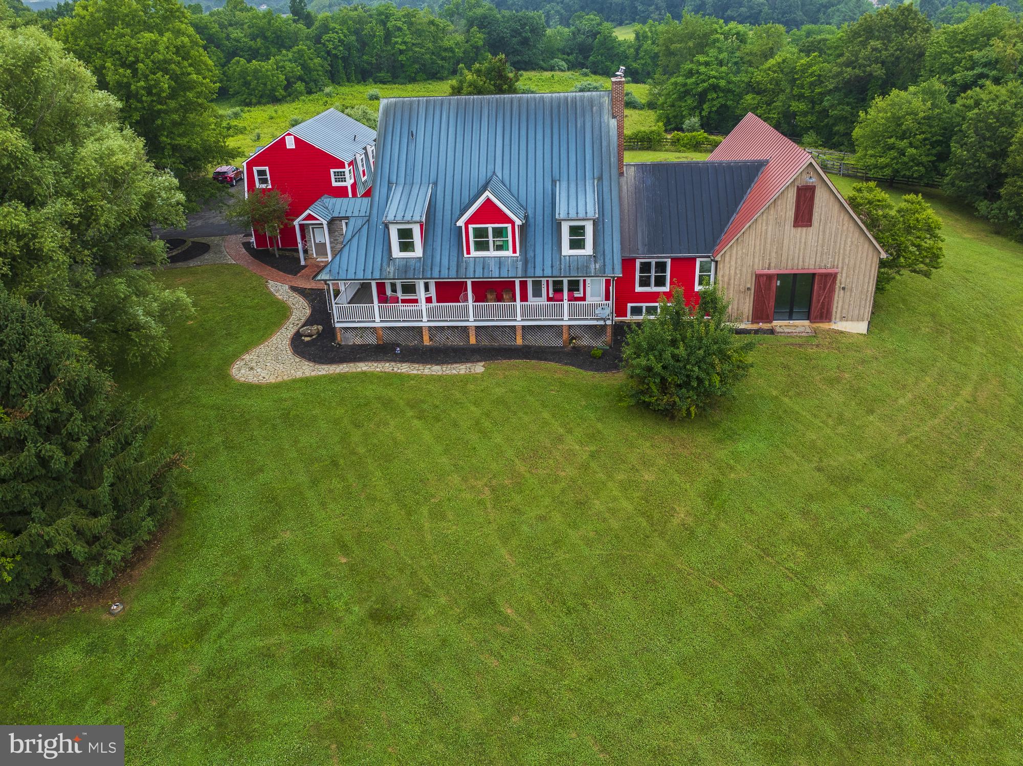 Rare opportunity to own Restoration Farmware, a proven luxury short-term rental and move-in-ready country retreat on 22 scenic acres in Purcellville, VA. HUGE INDOOR POOL! This spacious 5,500 sq. ft. farmhouse offers 4 bedrooms, 3.5 baths, multiple gathering spaces, a billiards room, lower-level entertainment area, private indoor pool, sauna, hot tub, deck, fire pit, and peaceful countryside views. Currently operating as a successful Airbnb, the property has generated approximately $140,000–$166,000 per year in rental income and features “Guest Favorite” status, a 4.96-star rating, and 150+ reviews.

Perfect for horses or livestock, the acreage is thoughtfully divided into three well-fenced paddocks, each with its own dedicated run-in shelter. A reliable year-round water system is plumbed directly to every paddock and outbuilding, eliminating the need for daily water hauling. Character-rich stone outbuildings provide flexible space for stabling, storage, equipment, or workshop use. Located in the heart of Loudoun County wine country, this rare property blends income potential, resort-style amenities, agricultural functionality, and timeless rural charm.

HUGE UPSIDE POTENTIAL WITH FINISHING THE RENOVATION OF APARTMENT ABOVE THE GARAGE.