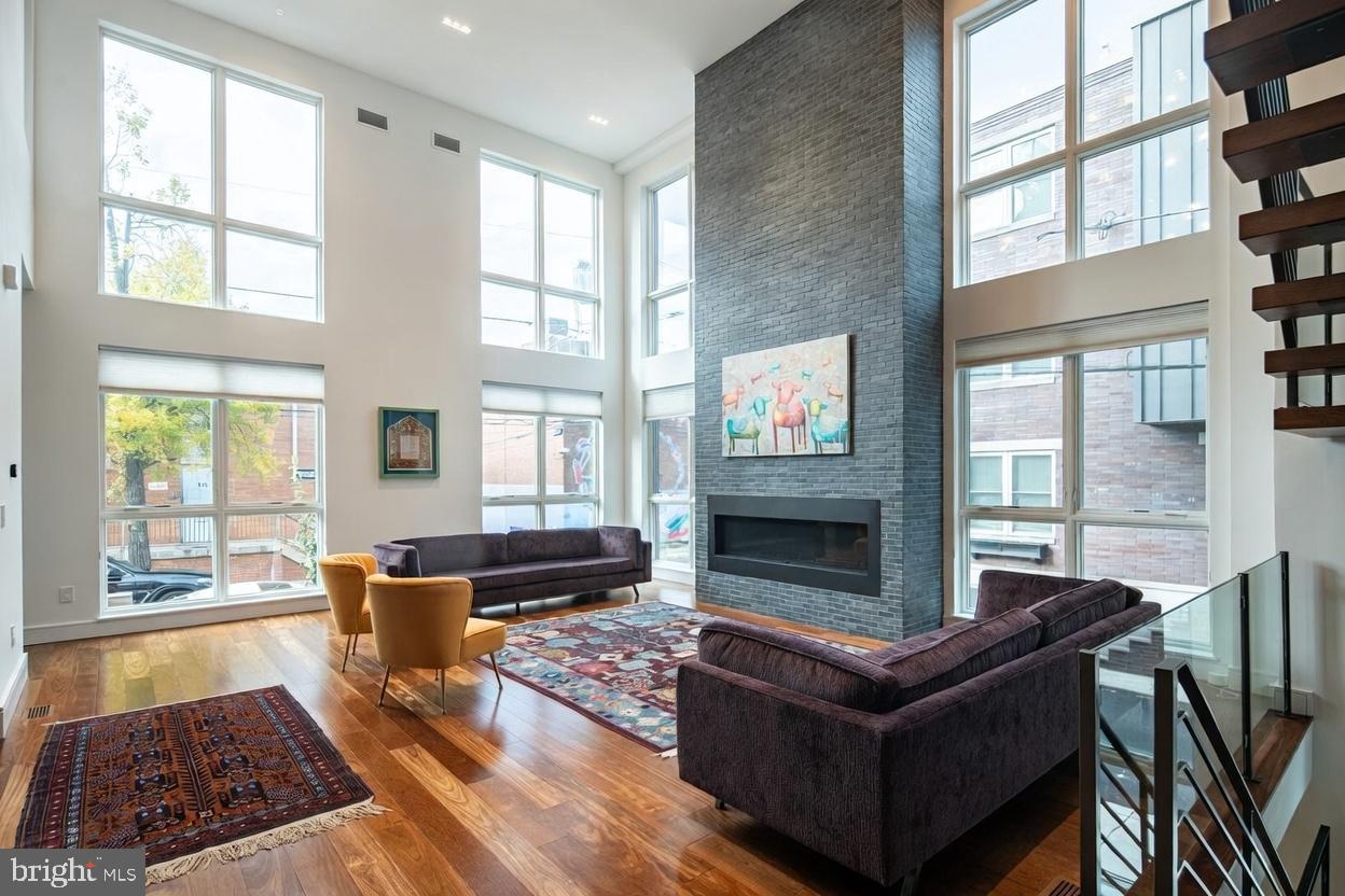 An Unrivaled Urban Masterpiece - This residence defies every expectation of City living. Spanning an extraordinary 60 ft (3 lots) and rising five levels, this 8,160 sqft modern icon is wrapped in floor to ceiling windows, soaring ceilings, and features six outdoor spaces (an additional 2,400 sqft exterior living space) with views from the Schuylkill River to the Center City skyline and beyond.

Main Level - An open expanse with heated-tile foyer and 22' ceilings. Brazilian Chestnut hardwood floors glow beneath a wall of glass, framing a majestic living room anchored by a large fireplace. The chef’s kitchen features a 15 ft quartzite island, Sub-Zero refrigerator, built-in Miele cappuccino station, six refrigerated drawers, and Pitt cooktop floating six-burner range built into the natural stone countertop. Exit the glass doors to your private terrace with built-in Wolf grill — perfect for dining al fresco. A discreet coat closet and powder room complete this flawless first level.

Second Level – An Intimate Retreat Awaits. Ascend to three serene bedrooms, each with en-suite full bath. A cozy reading nook opens to the second exterior living space — ideal for morning coffee. A full laundry suite keeps life effortless.

Third Level – The Primary Wing. The primary suite is pure indulgence: a crackling fireplace, private balcony, and spa bath with rain showers and sculptured freestanding tub, heated floors, bidet, and double vanities. Indulge in the expansive walk-in closet and dressing room. A separate guest bedroom with en-suite bath on this level ensures privacy for all.

Fourth Level – The Ultimate Entertainment Realm. The City is your backdrop with dramatic floor to ceiling windows surrounding a second entertaining kitchen with 10 ft natural stone island, Sub-Zero refrigerator, dual-zone wine cooler, and dishwasher. Two sprawling decks, a bubbling hot tub, built-in Wolf grill, and convenient half bath let you host a party or an intimate retreat — every inch is designed for unforgettable nights under the stars.

Rooftop Terrace - The crown jewel: a 360-degree 1,000+ sqft rooftop terrace floating above Philadelphia. Center City’s towers sparkle to the east, the Schuylkill glimmers below, and University City glows across the river. Sunrise yoga or midnight cocktails — this is your private sky lounge.

Finished Lower Level –  A rare daylight-drenched basement with radiant heat floors and full bath provide endless possibilities. Transform it into a golf simulator, screening room, gym, playroom, or sixth bedroom — the choice is yours.  2 car garage parking located directly off the lower level.

Additional Luxuries:
Eurofase lighting
4 Zones, 4 HVACs
Pella Architect Windows
Side by side two-car garage
Elevator stops on all five floors
Full 10-Year Tax Abatement began in 2023
Immediate Delivery

This is not just a home. This is one of Philadelphia’s largest and widest townhome— an urban oasis where scale, craft, and spectacle converge. Once you step inside, everywhere else will feel ordinary.  Schedule your private viewing of one of the city’s finest residence. Opportunities like this appear once in a generation.

LOCATION
10 min walk, 5 min drive → Schuylkill River Trail
12 min walk, 5 min drive → Rittenhouse Square
15 min walk, 7 min drive → CHOP, Penn, 30th St Station
15-25 min drive → Philadelphia International Airport
Walk Score® 98 | Bike Score® 92

Property owner is a licensed real estate agent.