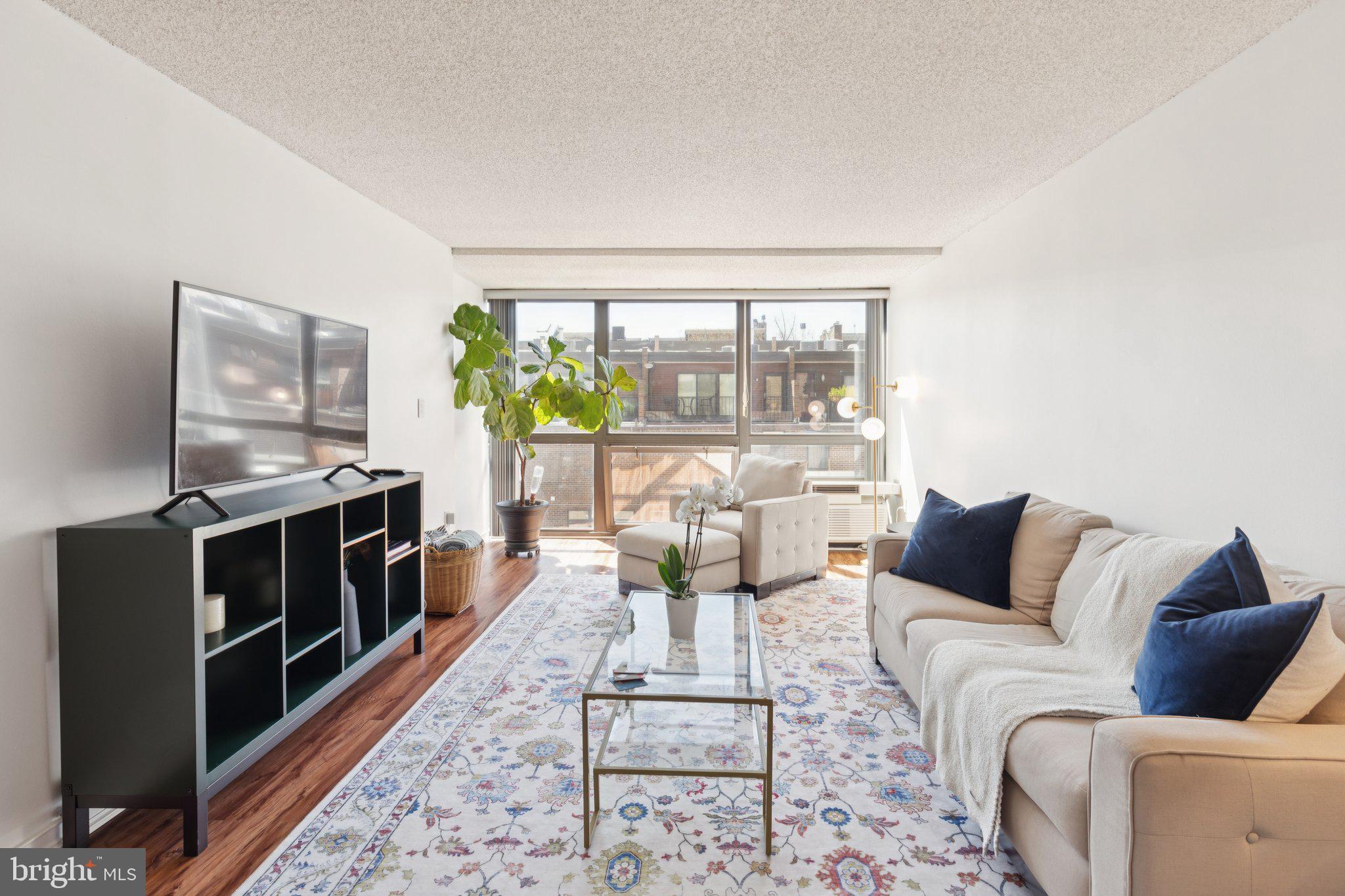 Completely updated one-bedroom with sweeping southern views at Independence Place, Tower I. A gracious entry foyer with a deep coat closet welcomes you into a sun-drenched great room where floor-to-ceiling windows frame stunning southern exposures and create an effortlessly bright backdrop for living, dining, and entertaining. The fully renovated kitchen is as functional as it is beautiful, featuring sleek wood cabinetry, granite countertops, a modern tile backsplash, stainless steel appliances and sink, recessed lighting, and a large passthrough with breakfast bar that keeps the space open and connected to the great room. The generously sized bedroom continues the theme of light and space with its own floor-to-ceiling window, a modern ceiling fan, a deep wall closet, and a walk-in closet. The updated full hall bathroom is clean and refined, offering a large white vanity, a glass-enclosed tub shower with crisp white subway tile, and a stone gray tile floor. Additional highlights include a dedicated laundry closet with stacked washer/dryer, abundant storage throughout, and warm updated flooring that flows seamlessly through every room. Residents of Independence Place enjoy a twenty-four hour doorman and concierge, a beautifully appointed lobby on the main level, on-site management, fitness room, and individual heat & air conditioning controls. Independence Place is located in the historic Society Hill neighborhood of Philadelphia facing Washington Square. Many of the city’s finest museums, cultural institutions, theaters and restaurants are only a short walk away. 30th Street Station and Philadelphia International Airport are only minutes away.