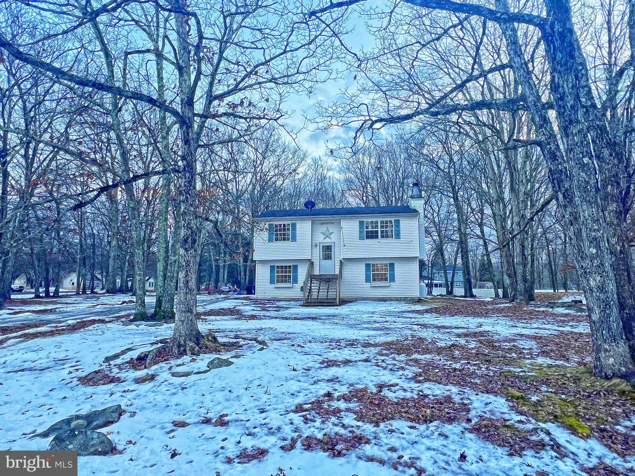 Updated 4 bedroom 2 full bath home in Bushkill can be yours! Vinyl wood floors and light modern paint throughout. Open concept large living room to the kitchen/dining area, that lead on to the deck overlooking the large private backyard of more than 2/3 of an acre. Two spacious bedrooms and a modern full bath on each floor that have been recently renovated. Lower level walk-out bonus room that leads onto the patio for additional entertaining space. The wide yard is flat and mostly cleared with wooded surroundings for privacy. Amenity-filled community with a lake, fishing, playground, swimming pool, pavilion, clubhouse, and basketball court.