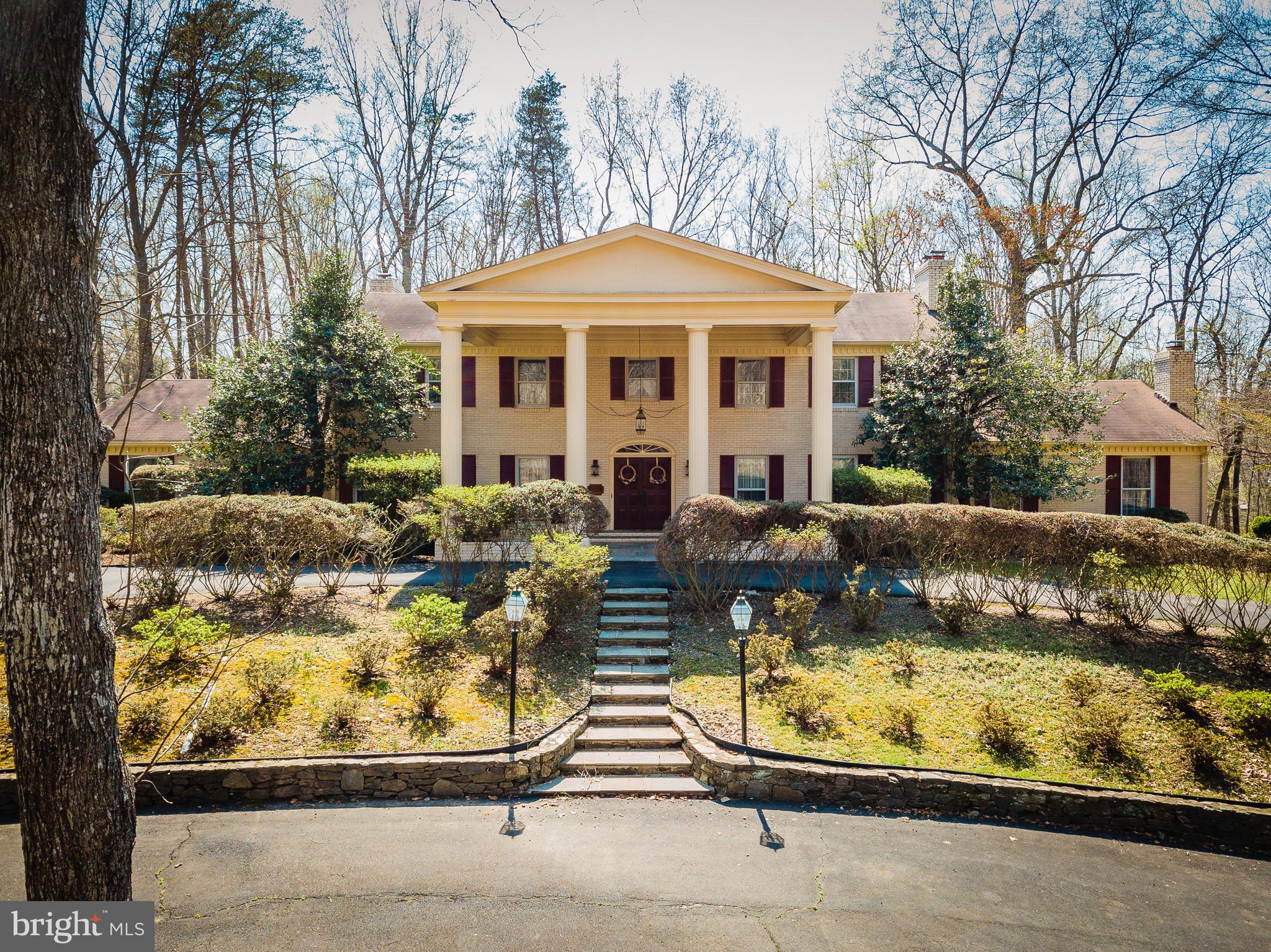 Experience peaceful country living on five private acres in Summerwind, a wooded equestrian community in Fairfax Station. This custom-built all-brick home offers over 6,300 square feet across three levels, blending  privacy with accessibility. Featuring six bedrooms, six full bathrooms, and four fireplaces, the well-maintained residence boasts spacious open rooms and an attached two-car garage. The main-level owner’s suite is expansive, offering a large bedroom with a sitting area, generous walk-in closets, a double primary bathroom with a dressing space, direct access to a private study or home office with a fireplace, and sliding doors leading to a tranquil patio. Upstairs, you’ll find five additional bedrooms, two renovated full baths, and a laundry room, while both the main and lower levels include full bathrooms for added convenience.

The vaulted foyer and curved staircase lead into a classic colonial layout, connecting the dining room, living room with gas fireplace, and a cozy sitting area with wet bar. The large kitchen features another gas fireplace, breakfast room with bay window and patio access, ample countertops, double ovens, an island with second cooktop, plenty of cabinets, and a pass-through to the dining room. The spacious family room has skylights, abundant windows, and sliding doors opening to the pool, patio, deck, and landscaped yard. The finished  basement includes walk-out stairs, a rec room with fireplace and wet bar, an exercise room with mirrored wall, and a den for hobbies or guests.

Summerwind is an equestrian community developed by John Ringle, featuring private roads and exclusive   bridle trails for members and guests. Located in Fairfax Station, residents enjoy quick access to shopping, dining, Burke Lake Park, George Mason University, Clifton, and Occoquan. Major commuting routes like I-95,    I-66, Route 123, and Fairfax County Parkway are nearby, along with Springfield Metro and Burke  VRE. The home is in the Sangster Elementary and Lake Braddock Secondary school zones. This tranquil setting offers a restful retreat from busy daily life.