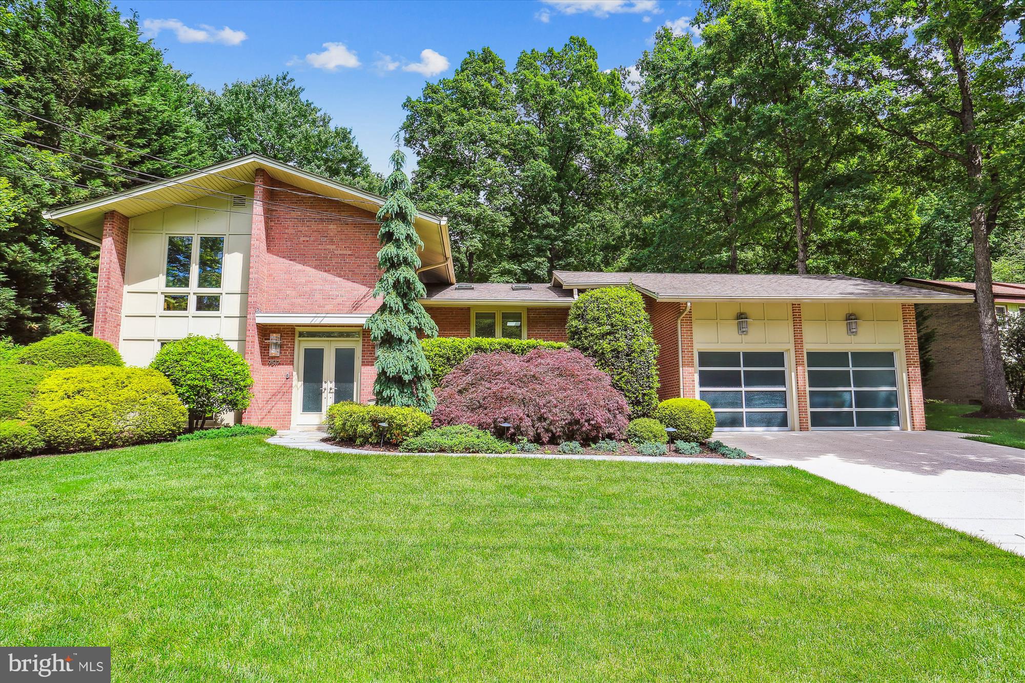 Located on a cul-de-sac, this stunningly renovated and expanded contemporary masterpiece blends metal, glass, granite, and Maple wood elements to create a sophisticated and unique character. Originally built in 1962, with major additions and renovation by renowned Architect Jeff Broadhurst, the design infuses European flair with modern luxury living spaces, accentuated by exquisite finishes throughout, including White Oak and maple floors, custom millwork, skylights, casement windows, French and pocket doors, modern ceiling fans, and other superb architectural details.

The front entry with limestone flooring opens to an elegant dining room featuring Maple and glass display shelving, which seamlessly transitions into the gourmet kitchen. The outstanding European-styled chef’s kitchen boasts custom maple cabinets with German shelving and drawer systems, Quartz countertops, an island, a stainless-steel exhaust hood, a pot filler, Sub-Zero maple (not stainless steel) paneled refrigerator, a GE gas range with a double oven and 6 burners, solid granite backsplash, decorative pendant lighting, and access to the picturesque synthetic side deck. Beyond the kitchen is the inviting family room, with a wood-burning fireplace and a honed granite wet bar, while the unbelievable library/office impresses with built-in maple and steel shelving, exposed ductwork, and brick walls. The main level also includes a powder room, smart home hub, and front entry coat closet.

Up a few stairs from the foyer, a sun-drenched living room with skylights opens to a large stone terrace with a water fountain, seamlessly connecting indoor and outdoor entertainment spaces. The spacious heated sunroom, accessed via the library and terrace, features brick walls, a tongue-and-groove ceiling, and a gas fireplace.

There are two stairways to the upper level; the primary suite’s floating steel staircase with maple treads is located off the library and is an architectural focal point. The primary suite, boasting sleek design, features extensive custom dressers with Maple wood and honed granite elements, floating nightstands, a custom bedframe, an incredible light box skylight with a retractable blind, three walk-in closets including a shoe closet, a sumptuous spa-style bathroom with a double vanity, a steam shower, heated floor, and laundry facilities. There are three additional bedrooms and a renovated hall bathroom with a double vanity on the upper level.

The lower level has a comfortable recreation room, den area with a desk, and storage space with a utility sink. There is a two-car garage with storage and an EV charging station, plus a floored attic space above the garage, providing additional storage options.

Outside, the scenic fenced backyard highlights mature landscaping, stone hardscaping, a large stone patio, and a deck off the kitchen—an ideal spot for grilling.

The Wyngate neighborhood is valued for its convenient location, lovely homes on quiet tree-lined streets, and proximity to shops, restaurants, NIH (The National Institute of Health), the YMCA, and Downtown Bethesda. Easy access to I-495 and I-270. Steps to the much-beloved Wyngate elementary school, Old Georgetown Swim Club (membership pool), and Wyngate Woods Park. Schools:  Wyngate Elementary, North Bethesda Middle, and Walter Johnson High School