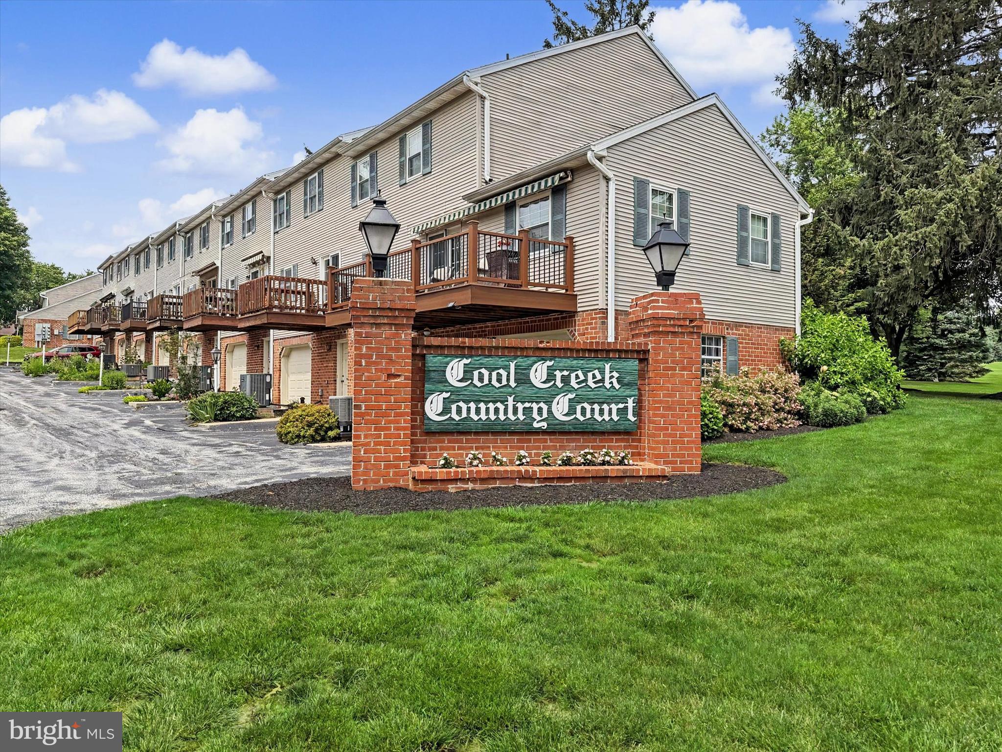 Enjoy the golf course view from the deck with an automatic awning, maintenance free living at it's best, with hardwood floors thru out the 1st Floor , the Kitchen has a Bosch dishwasher, Granite & Corian countertops, ceramic backslash and a 2 year old Refrigerator, the Living Room/Dining Room has a gas fireplace and a door to the deck, the Primary Bedroom Suite Bath has a walk in shower, walk-in-closet, a double bowled sink and skylight, the 2nd Bedroom has 3 closets and an access panel to attic storage.  All closets have organizers, the Lower Level is partially finished with cabinets and sink and  could be finished for a Family Room, this is the location of the Laundry, storage and built in garage, the home has been repainted, the 30 year Roof was replace in 2025, there are front and rear faucets.  The Public Golf Course offers a Bar/Lounge, Club and course .
