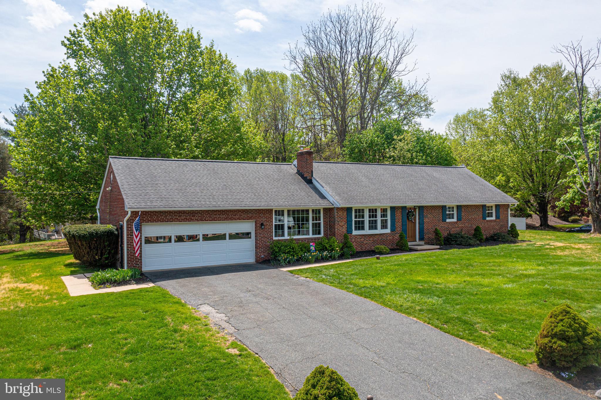 As the saying goes:  "Location, location, location!".  Welcome to this beautiful solid brick rancher on a double lot, tucked away in a small neighborhood off of a country road just off of Bel Air Rd, and literally seconds from gas, dining and groceries, and only minutes from I-95.  This well built home, has been renovated and fully updated by the current owners, and comes with 3 bedrooms, 2 full baths, and a 2 car garage.  The main floor has wood flooring throughout and offers modern open-concept living with the living room and formal dining area both being open to the modern kitchen.  This gorgeous kitchen has a quartz island, and quartz countertops, tile backsplash, updated stainless appliances, and deep porcelain farm sink.  Standing in the kitchen looks out over the living room with a wood burning fireplace and bay windows, and to the side is the dining area which has sliders that open out onto the rear yard and courtyard style patio.  A door off of this main living area opens out into a finished living space that used to be a breezeway but now has been transformed into a cozy family/living room area.  Doors off of this room lead out into the two car garage.  Back inside the main living area a hallway leads to a fully modernized finished hall bath with a granite topped vanity and subway tile around the shower/bath tub combo.  There are three bedrooms in this hallway including the owners suite which has its own full modern bath with a granite vanity and large tiled walk in shower with a glass door.  Taking the stairs to the basement leads to another large carpeted living/recreation room, as well as a storage area that hosts mechanicals as well as laundry facilities, and another room that could serve as a workshop/hobby room, or more storage.  Outside this home sits on a large corner double lot with a large grassy front yard and part cleared, partly wooded rear yard with a storage shed, and children's play set.  The concrete patio has a courtyard style finish to it with a low brick wall surrounding it, and is perfect for relaxing and enjoying the peace and beauty surrounding the property.  This is the best of both worlds with country/suburban charm and modern elements and upgrades, all while being just a stones throw from all major thoroughfares, shopping and dining.  Don't miss it, come see it today!