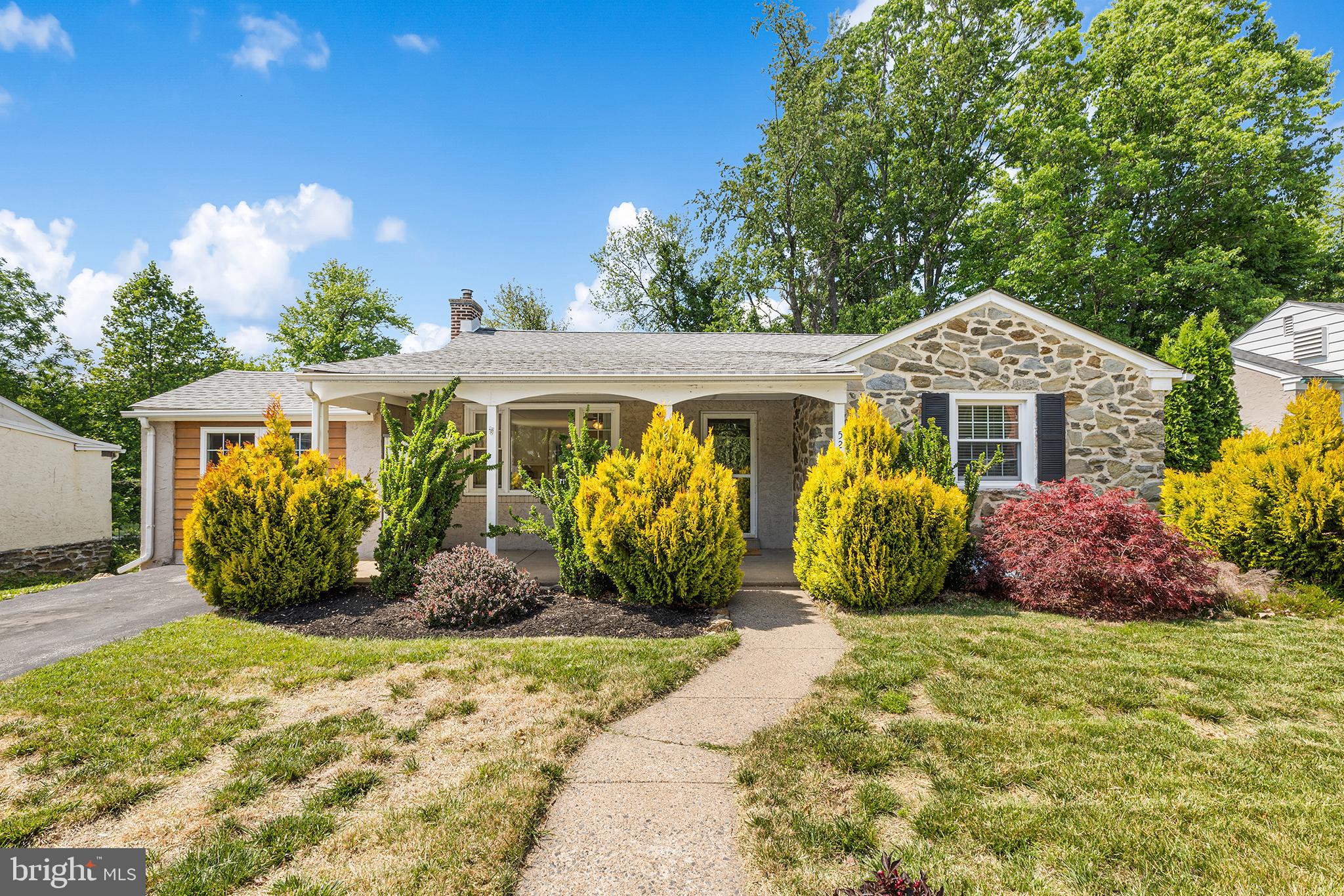 Welcome home to this spacious 4-bedroom ranch in the desirable Pilgrim Gardens neighborhood of Drexel Hill, offering a flexible layout and comfortable one-level living with added space below. Inside, discover beautiful hardwood flooring and an open-concept layout where the bright living area flows seamlessly into the dedicated dining space and upgraded kitchen featuring stainless steel appliances. Sliding glass doors lead directly to a large rear deck overlooking a private backyard, creating the perfect setting for outdoor dining, entertaining, or relaxing. The main level includes three generously-sized bedrooms and two full bathrooms. The finished walkout lower-level expands the home's living space with a cozy family room/den highlighted by a dramatic floor-to-ceiling window showcasing the peaceful tree-lined rear yard. This level also offers a fourth bedroom, third full bath, bonus room ideal for a home office or gym, plus a spacious laundry room for added convenience. This home combines space, versatility, and a great location all in one package. Mortgage savings may be available for buyers of this listing.