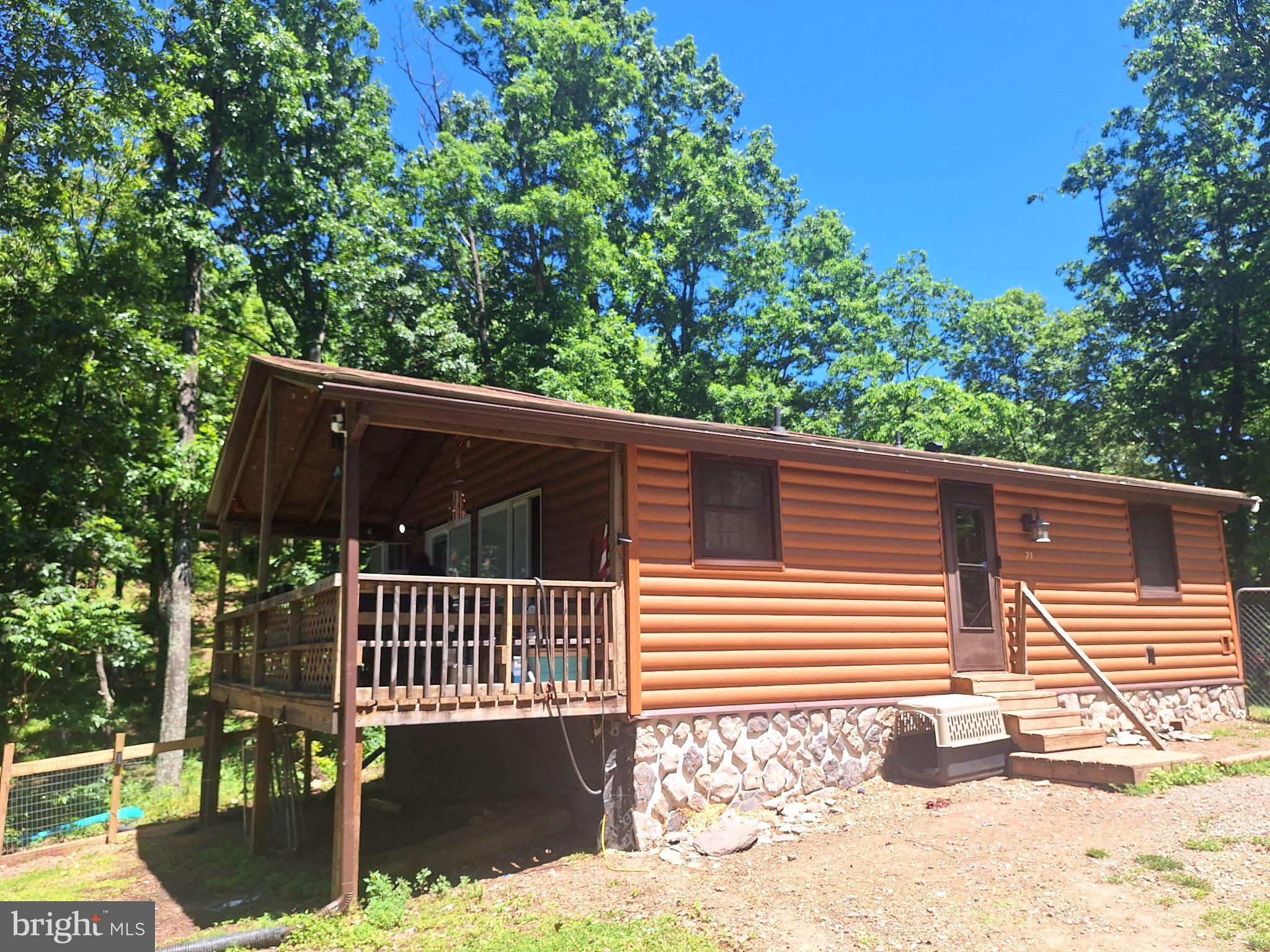 Welcome to your private mountain retreat in Hedgesville, West Virginia. Nestled on approximately 1.35 wooded acres, this charming cabin offers the perfect escape from the hustle and bustle of everyday life while providing access to some of the area's best outdoor recreation.
Renovated in 2020, the cabin features warm, inviting living spaces and a cozy pellet stove that creates the perfect atmosphere for relaxing after a day of fishing, hunting, hiking, or exploring the surrounding mountains, making this an ideal weekend getaway, vacation home, or investment opportunity.
Gather around a fire pit, entertain on the property, or simply relax and take in the sights and sounds of nature.
State game lands await to be hunted at your backdoor. Community also includes a small beach area and a lake for swimming and small non motorized boats.
Located within easy reach of Martinsburg, Berkeley Springs, Sleepy Creek Lake and other popular destinations, this cabin combines seclusion with accessibility.