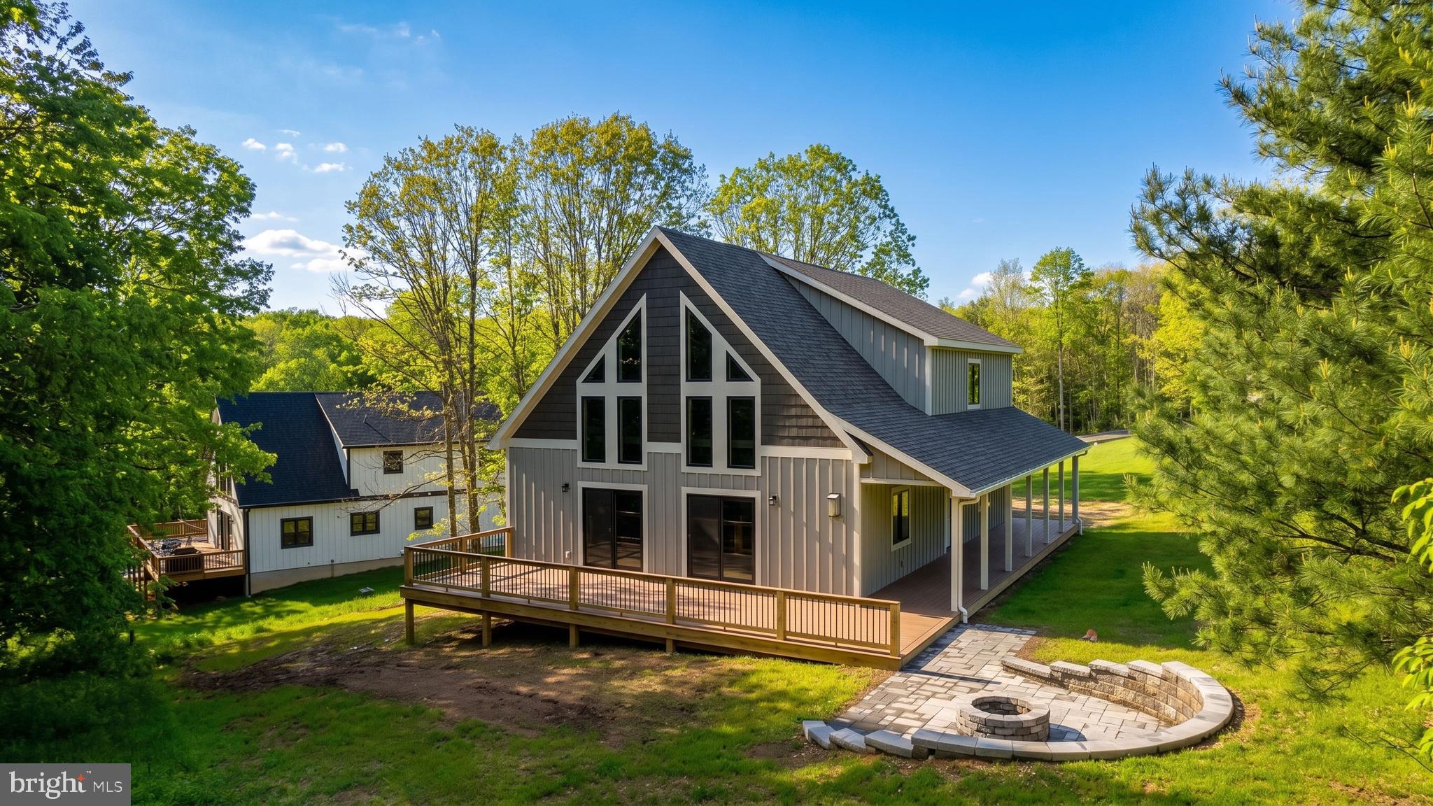 NEW CONSTRUCTION Modern Mountain Home Located in the Heart of Deep Creek Lake. This 4-bed, 4-bath luxury Chalet is located on a private cul-de-sac, just minutes from local establishments, marinas, and WISP Resort! Open concept living, engineered hardwood with vaulted tongue-and-groove ceilings, and propane fireplace. Modern kitchen with island, stainless appliances, and granite counters.  Main level primary suite. Elegant baths with gorgeous tiled showers. Enormous loft overlooking the floor-to-ceiling glass in the great room, perfect for additional living space or game room. Plenty of outdoor living with a wrap-around deck and built-in fire pit patio. Just waiting for your finishing touches to call this place home… Call today for your private showing!