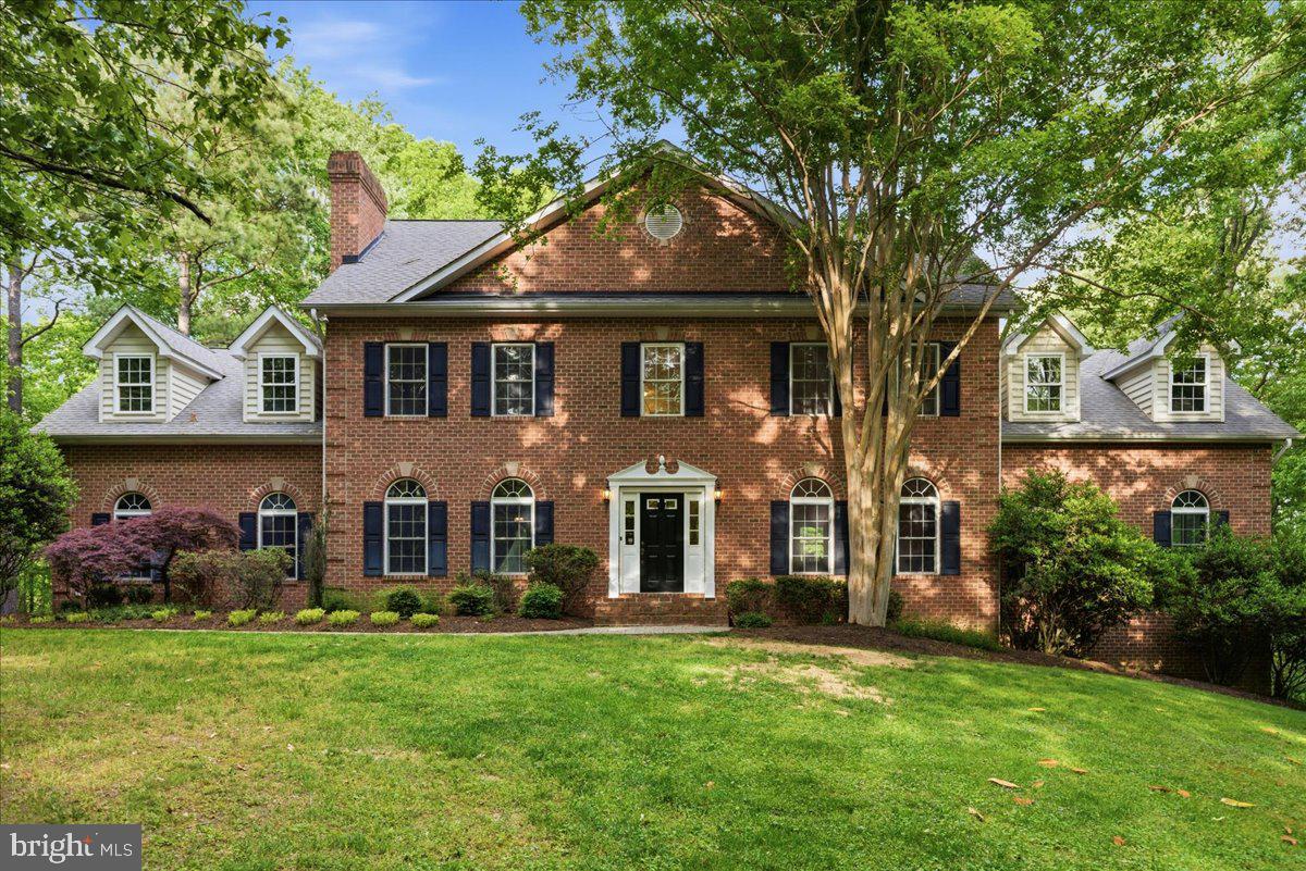 Luxury home on 5 private wooded acres in sought-after Calvert County, Maryland with Chesapeake Bay boating access. Bordered by 121 acres of protected community open space, this property offers rare privacy, natural views, and resort-style amenities.

The oversized kitchen features solid cherry cabinetry and expansive prep space ideal for entertaining. Main level includes a dramatic second family room with soaring ceilings and abundant natural light.

Upper-level primary suite retreat with gas fireplace, sitting area, dual walk-in closets, and spacious bath. Convenient upper-level laundry with direct primary suite access.

Finished walk-out lower level includes theater room, custom bar crafted from on-site wood, secondary kitchenette, and fitness or hobby room.

Outdoor living features a heated 9-ft deep gunite pool with diving rock and fountain. Underground sprinkler system for yard. Community marina and boat ramp on Saint Leonard Creek off the Patuxent River for boating, fishing, and waterfront recreation.

Private acreage. Luxury features. Southern Maryland lifestyle.