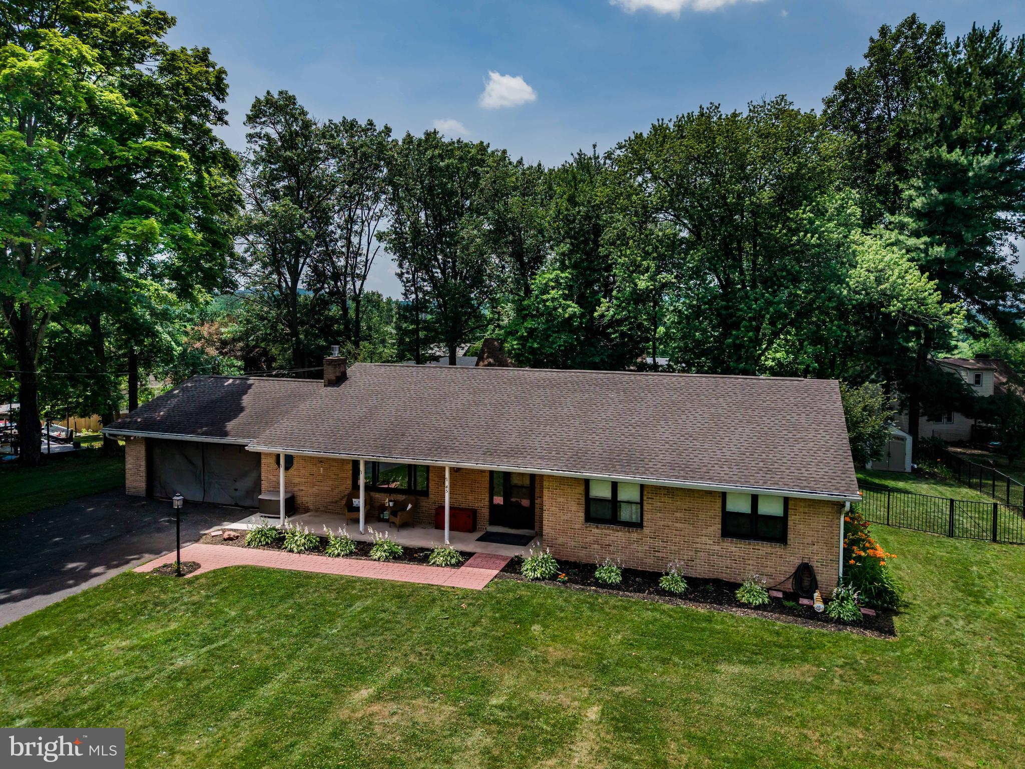 Welcome to this spacious, ranch-style home situated on 0.43 acres that is located within sought-after West Shore School District and Newberry Twp.  Well maintained, this home features an exceptional floor plan with 3 bedrooms and 2 full baths, offering over 1,600 sq ft of living space. Step onto the charming covered front porch and enter into the spacious foyer, which leads to the dining room and large family room with a gas fireplace. The lovely kitchen includes Formica countertops, stainless steel appliances, and luxury vinyl plank flooring, as well as a BREAKFAST NOOK. The dining room boasts a sliding glass door that opens to a convenient patio and second larger concrete patio that overlooks a private, truly amazing flat, and FENCED in backyard that is PERFECT for entertaining and/or relaxation. Down the hall, you'll find two generously sized guest bedrooms sharing an updated hallway bathroom and a shower/tub combination. The primary bedroom has hardwood floors with full bathroom. The unfinished basement offers ample storage space and the flexibility to be finished to suit your needs. Off the garage, you will find the laundry/mud room. Newer Roof (2019).  A must-see!