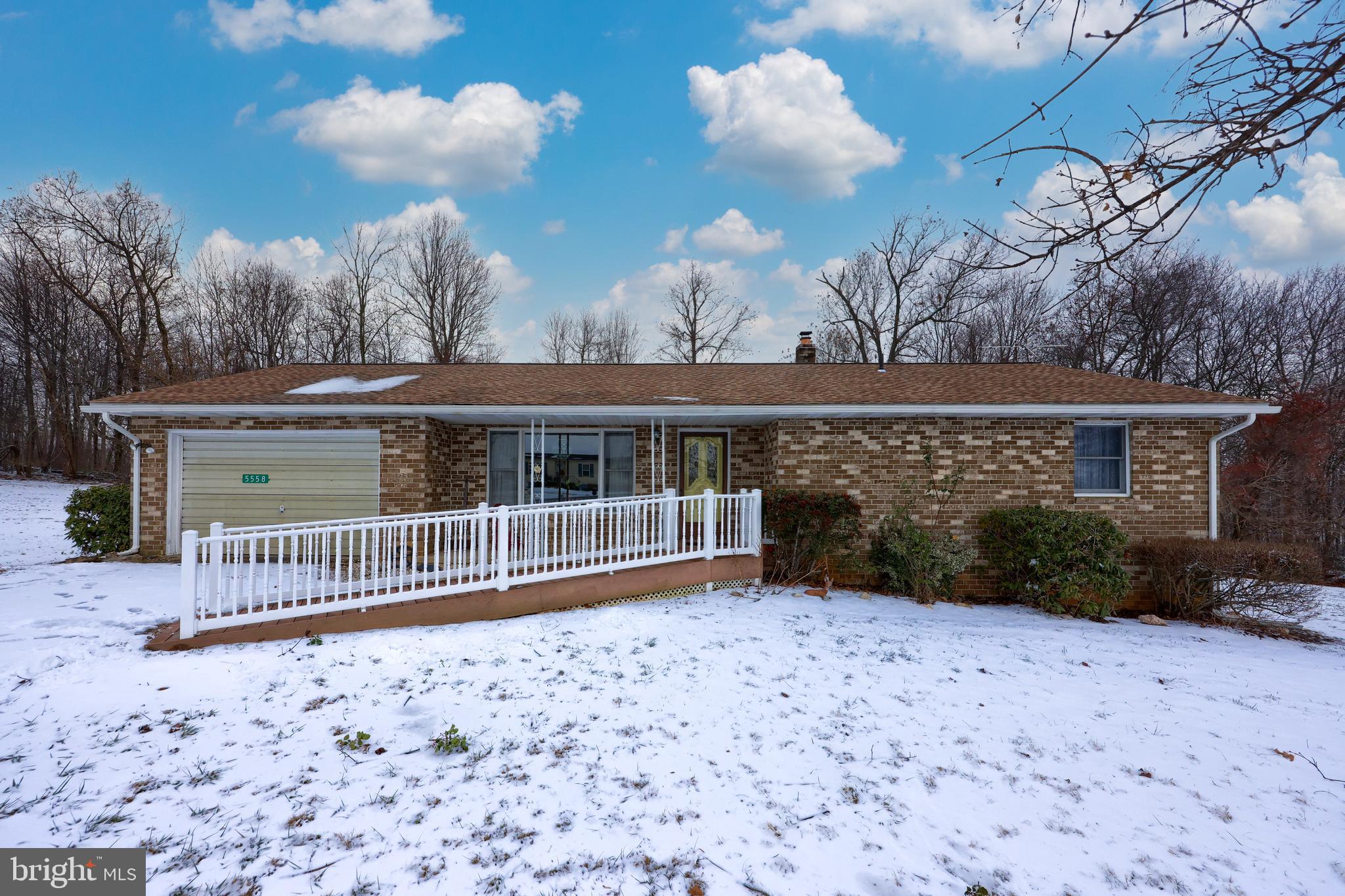 This cute, cozy rancher is situated on a large lot in a rural setting, but is still convenient to restaurants and shopping. Enjoy the lovely view from the recently added back porch. Two main level bedrooms and baths, main level laundry along with front ramp make this home very attractive to those looking to get away from stairs. Lower level has tons of storage as well as a den and third bedroom.  Some updates include newer roof, spouting, gutters, paint, hot water heater and kitchen countertops. Great location for Maryland commuters. March settlement preferred.