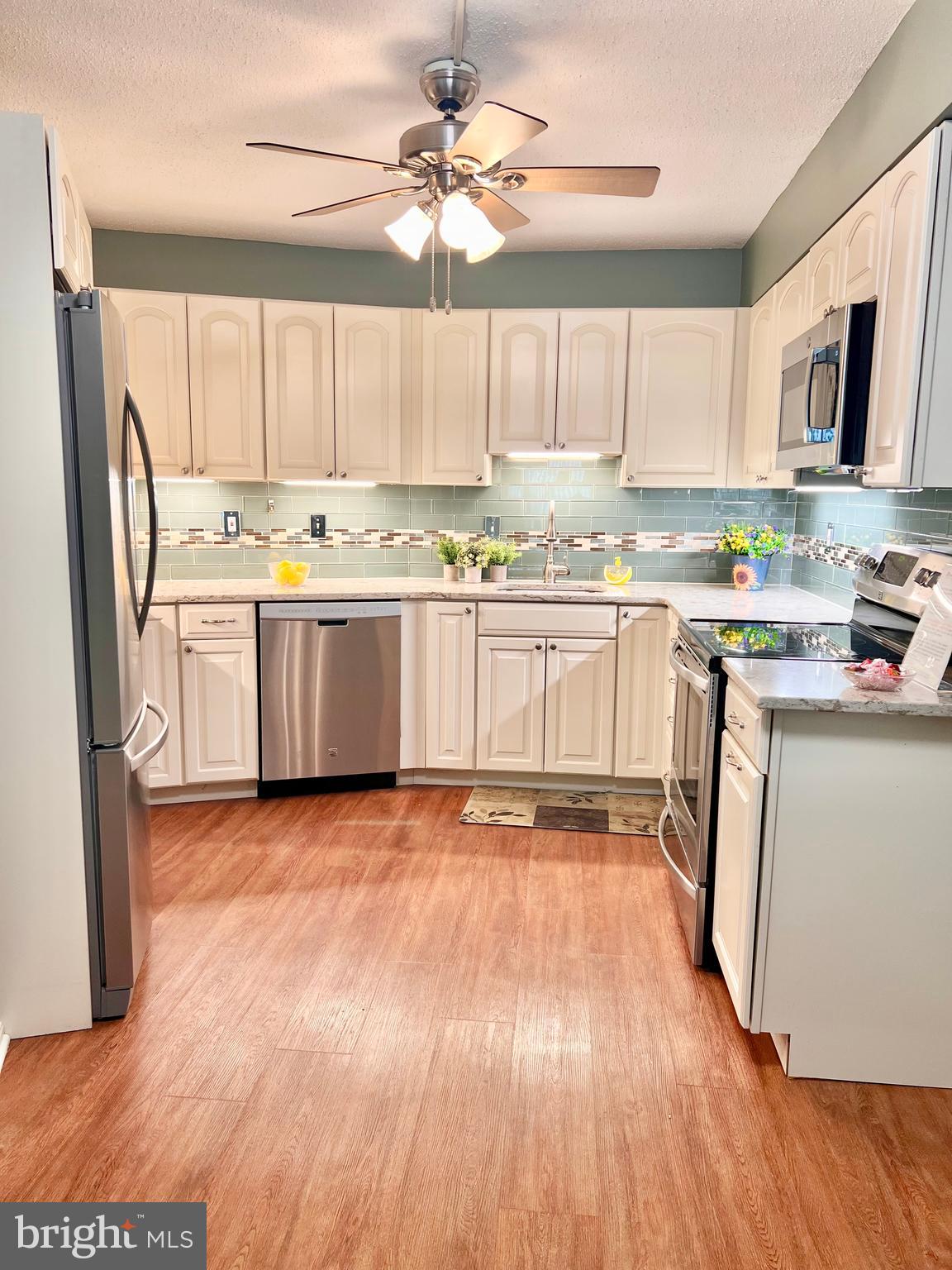 55+ Gated Community - Beautifully updated “J” Model with 2 bedrooms, 2 baths, which includes a garage space off the lobby level (4-85) and a storage cage (#229).  The table space kitchen is remodeled with quartz countertops, stainless steel appliances, white cabinetry with soft close drawers and undercabinet lighting too!  The baths have been remodeled too! The large, enclosed balcony off the living room is also accessible from the 2nd bedroom.  Freshly painted and the recent carpet has just been cleaned.  Large rooms and comfortable living await!  The monthly fee includes both the condo and HOA fees, water/sewer, basic cable TV, Wi-Fi and the wonderful community amenities.  It's resort living – with 2 clubhouses, a fitness center, indoor and outdoor pools, walking trails, tennis & pickleball courts, game rooms, 18-hole golf course, restaurants, clubs, activities, and much, much more!  And the grounds are so beautiful with abundant green space and delightful wildlife.  Come see for yourself!