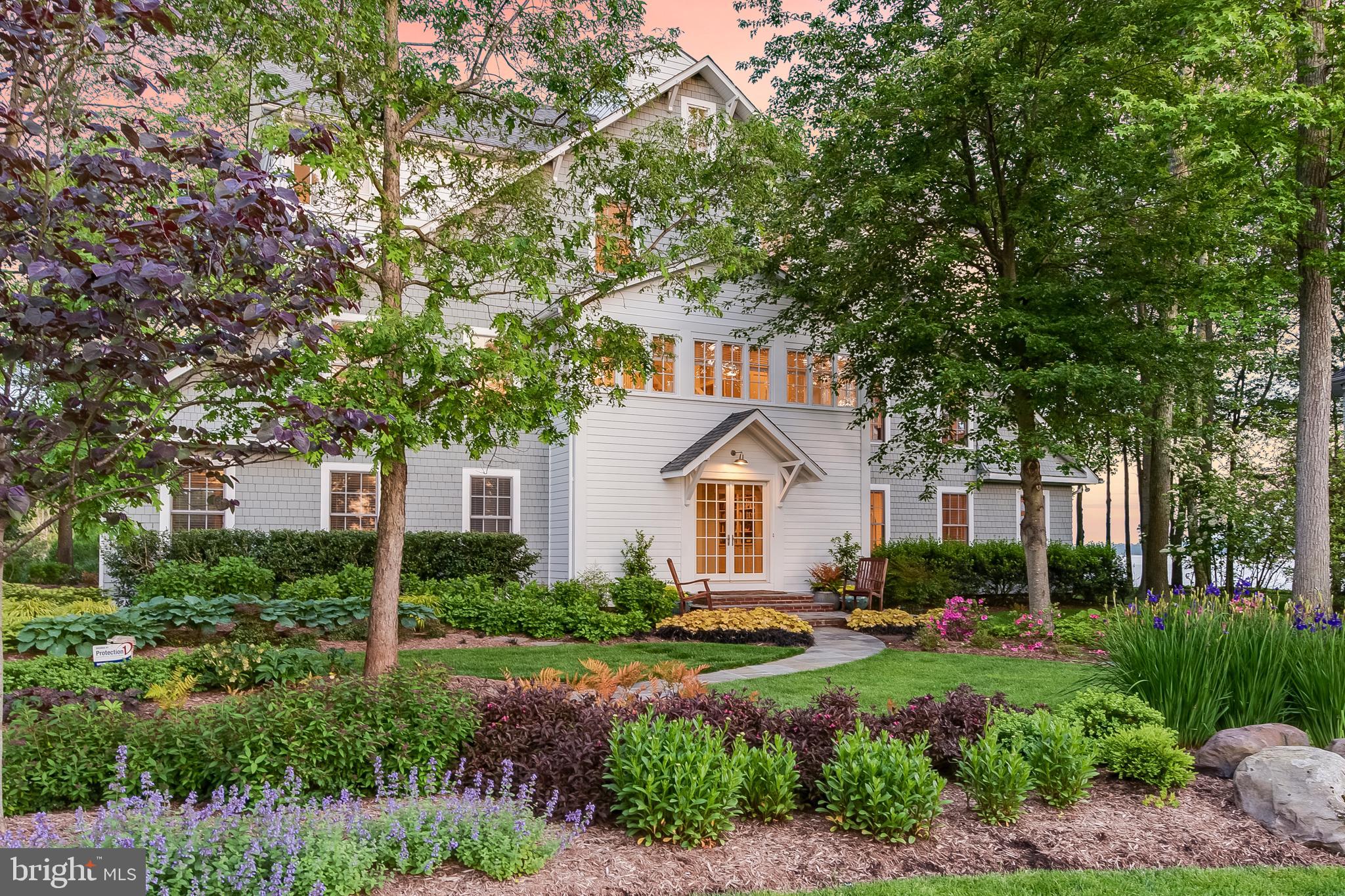 One of the prettiest residences in all of Annapolis!  Offering water vistas with welcoming sunrises over the Chesapeake to vibrant sunsets across the South River, this waterfront home with beach exudes warmth and subtle elegance with its open and airy design, fine details and water views from almost every room. Highlighted by architectural symmetry, balance and proportion centered around an elegant, award-winning staircase framed with wood slat boards and cupola above. Over 5000 square feet of living space with an abundance of natural light throughout from over 100 windows and glass doors all complemented by a muted color palette. Comfortable and gracious living spaces indoor and out including 4 bedrooms, 3.5 baths, 2 fireplaces and three waterside porches plus a deck at waters edge or indulge in kayaking, windsurfing, and sailing your catamaran from the beach. Community marina, pool, tennis and trails. Recent improvements of over $300,000 include  new roof, master bath, kitchen and more. Designed by Muse Architects, experts in residential, institutional, commercial, urban design, and interior design projects.