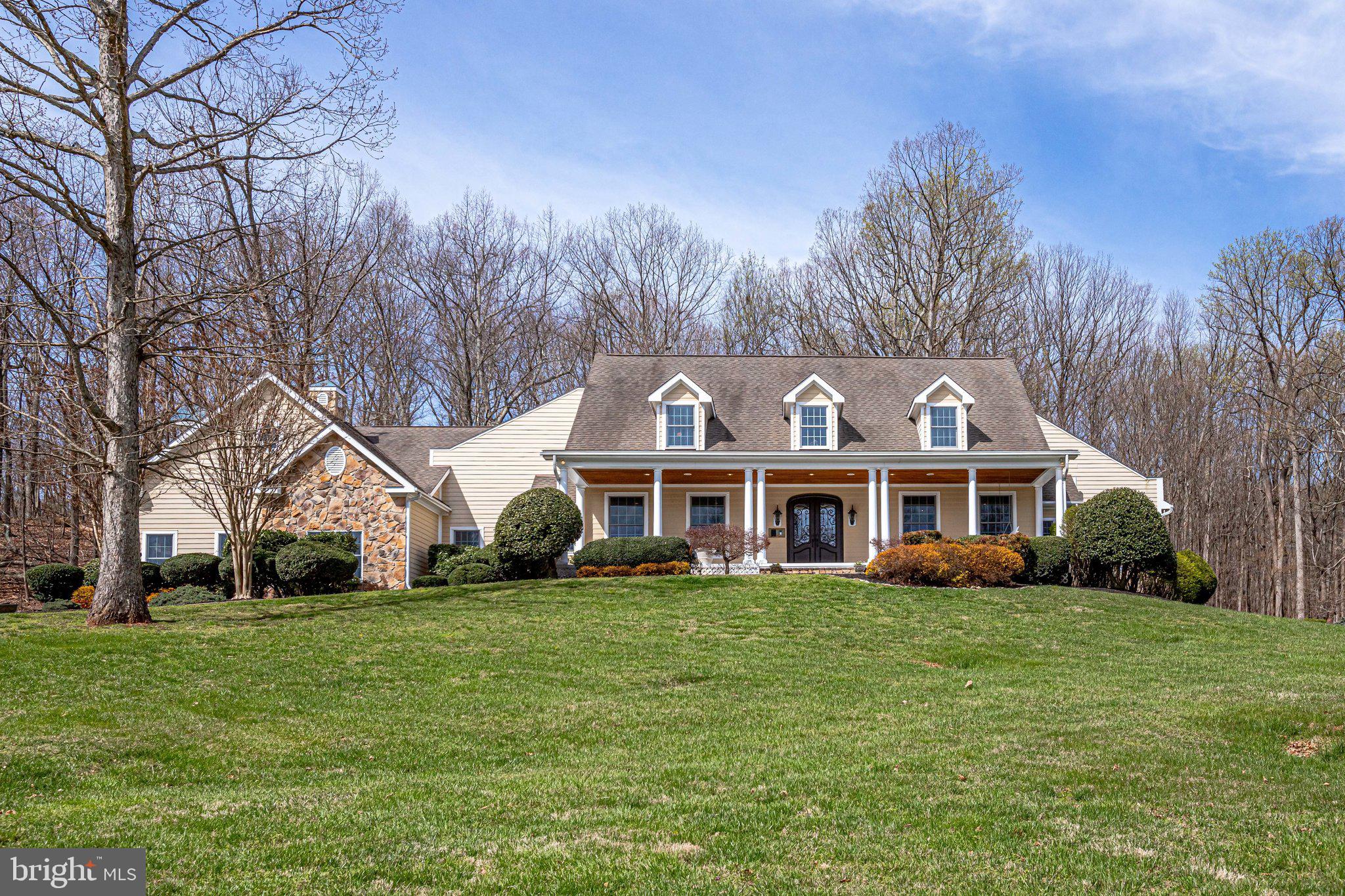 Come settle in on your own private 10 acre estate.  Over 8700 finished sq ft, plus a pool, hot tub, fire pit and patios fill out this private oasis.  Enjoy lazy Saturday mornings from this oversized front porch, drinking coffee and listening to the birds chirp.  Enter the Main level through a large, two story foyer which leads into the gourmet Chef’s kitchen with large center island, high end cabinetry and appl: Thermador double ovens and Thermador 5 burner stove, Viking refrigerator, Kitchen Aid Dishwasher, granite counters, hardwood floors and a Walk in pantry. Huge breakfast room overlooking the tranquil backyard.  Kitchen flows into the large family room with a wood burning stone fireplace.  Just past the family room is a bright and airy sun room overlooking the pool. The screened in deck off the back of the house makes summer evenings bug free. Main level also boasts an in law suite with full en-suite bath, an executive dining room, and an additional room could be used as a living room, library, or office.  Upper level:  Primary suite with separate sitting room, newly remodeled luxury  bath; soaking tub, dual vanity, large dual walk in closets with dressing area.  Princess suite with en-suite bath and walk in closet. A third oversized bedroom with large closets. Two very large bonus/flex rooms upstairs make great home offices, guest rooms or play/craft rooms.  Upper level also has a laundry shoot and two large storage closets. 
Take the party to the lower level to the huge custom built bar with a full sized refrigerator, dishwasher and sink.  Just beyond the bar is an incredible billiards room, a spacious workout room, and a Professionally designed recording studio, a three person steam shower and a separate craft room/study.  An additional family room with a fireplace.  House is wired with CAT5.  HVAC replaced 2015. Despite all the space inside, you’ll likely find yourself outside on one of the decks or patios, lounging by the heated in ground pool, soaking in the hot tub or sipping a glass of vino by the custom built fire pit.  Soak up  the tranquility in your private 10 acre oasis. So much space for entertaining and cozy nooks, this house has it all!  The owners have loved this home and all of its precious offerings;  the privacy, rocking on the front porch, pool parties, cookouts, the family gatherings, birds & other wildlife, sunsets and so much more. Now it’s time for your family to create your own happy memories here.
