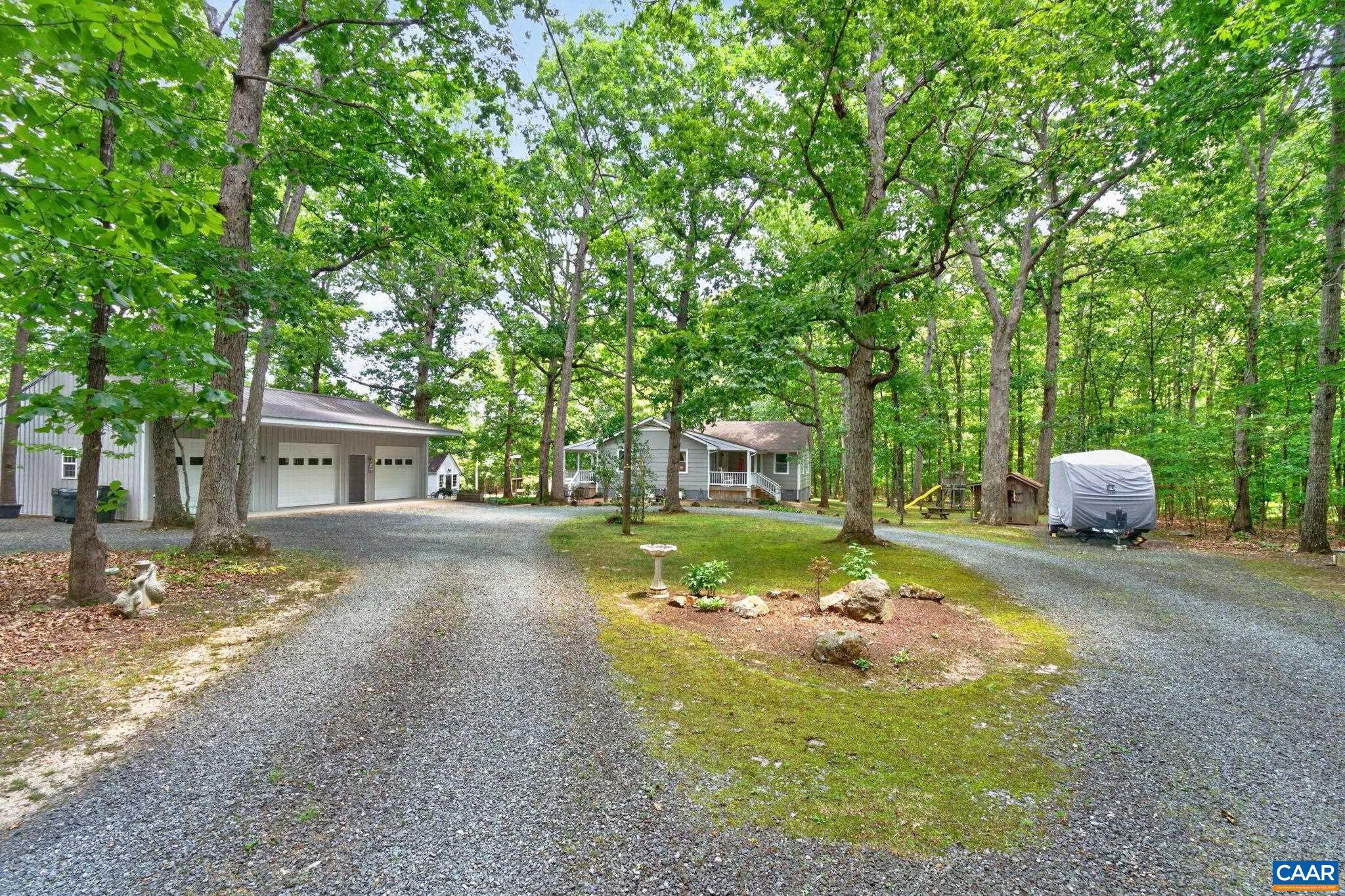 Escape to your own private retreat with this beautifully updated 4-bedroom, 2-bath home nestled on 2 landscaped acres. This property offers the perfect blend of comfort, character, and ample space for growth, making it move-in ready. Inside, you?ll find stunning hardwood floors throughout the first floor, custom-built-in bookshelves, and a kitchen that boasts thoughtful updates for everyday living. The renovated bathrooms bring modern style and convenience to the home. Replacement windows, a new heat pump, and a 3-year-old architectural shingle roof provide peace of mind and energy efficiency for years to come. The home also features a walk-up attic with ample storage and a spacious basement with great potential for future expansion, giving you the flexibility to create additional living space. A detached three-car garage with electricity offers plenty of room for vehicles, hobbies, or a workshop.