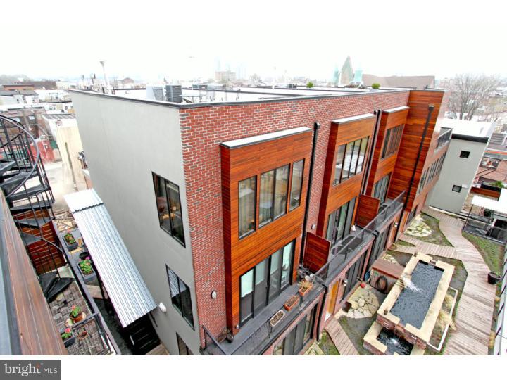 LEED Certified Ice House Condo in Fishtown. A premier unit is available offering a spectacular Private Green Roof, tankless hot water heater, 0 voc paint, and built using sustainable and locally sourced materials and no construction waste! This 1 bedroom 1 bath condo features, oak floors throughout, stunning floating steel stairs, large casement windows, custom kitchen with upscale stainless appliances, huge Caesar stone island, flat panel cabinetry, and glass back splash. Slider doors lead to a deck off of dining area. Spacious bedrooms on 2nd floor with large glass tile bath. There are incredible panoramic roof top views of Center City and the river. This bi-level unit is flooded with natural light. The common grounds include a beautiful fountain serviced by the properties runoff management system. Located in walking distance to everything the Frankford Arts and Girard Ave corridors have to offer including cafes, shopping, fitness, restaurants, and galleries.