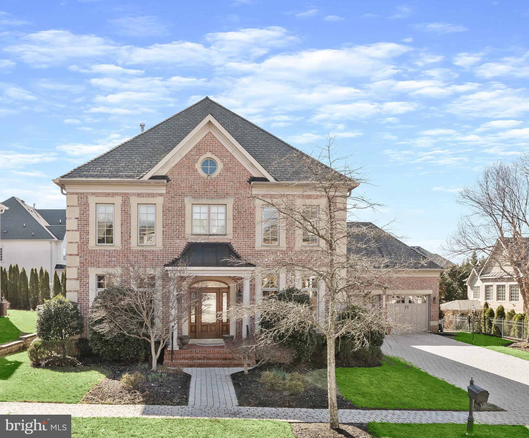 Just Listed & Open By Appointment!! Prominently sited on over a quarter acre lot in the Oaks in North Bethesda, this special Colonial home combines exquisite finishes and an enviable floor plan to create a unique offering in an unbeatable location of a wonderful private enclave of homes. High ceilings, custom woodwork, expansive entertaining spaces, generous bedroom suites with spa-like baths are on display throughout the 6,650 square foot home’s 5 bedrooms, 5 full bathrooms and 2 half bathrooms. Enjoyment of the outdoors is enhanced from a screened porch with vaulted ceiling and skylights. The property showcases mature landscaping with professional lighting, desirable rear decks, one with a built-in grill, and a picturesque patio to create an idyllic setting for al fresco dining and entertaining. This showpiece offers the perfect pairing of functional yet vast living spaces for a seamless and comfortable lifestyle.   
Soaring 10’ ceilings, gleaming hardwood floors span the Main Level’s open concept living spaces. A Study, complete with beautiful built-ins, and the formal Dining Room flank the home’s entryway. Designed to be the heart of the home is the generous Gourmet Kitchen with stainless steel appliances, eating space and a large center island which opens to the expansive Family Room, providing the perfect gathering space with utmost ease in mind. Beamed ceilings, custom entertainment built-ins and a gas fireplace with floor-to-ceiling stone create an air of coziness and comfort for intimate gatherings or larger scale entertaining. The home’s rear deck and patio, boasting extensive hardscape and a built-in BBQ grill, and Screened Porch complete with skylights, are directly accessible from the Family Room for effortless entertaining. One of two luxurious Primary Suites is located on the Main Level and features two large walk-in closets, and an ensuite bathroom with dual vanities, a soaking tub and large walk-in shower. Completing the Main Level is a Powder Room with custom glass bowl, Laundry Area and an attached, extra large, 2-Car Garage with built-ins for extra storage. 
A highlight of the Upper Level is the expansive second Primary Bedroom Suite, outfitted with lighted tray ceiling, a charming Sitting Room with columned entry, a generous fully organized walk-in closet and a spa-like bath. Two additional Bedrooms are located on the Upper Level. Both Bedrooms have ensuite Bathrooms. One Bedroom features an attached office with a built-in desk, credenza and audio center.  
The Lower Level is where multifunctionality and luxury living meet. Offering an expansive Recreation Room, Golf Room, Exercise Room and fifth ensuite Bedroom and large storage area, the Lower Level provides space for a variety of activities with flexible living and entertaining spaces.
This home is ideally located. Easy access to 495, 270 and Grosvenor Metro, Wildwood Shopping Center,  Pike and Rose, Cabin John Park and many shopping options are in close proximity.