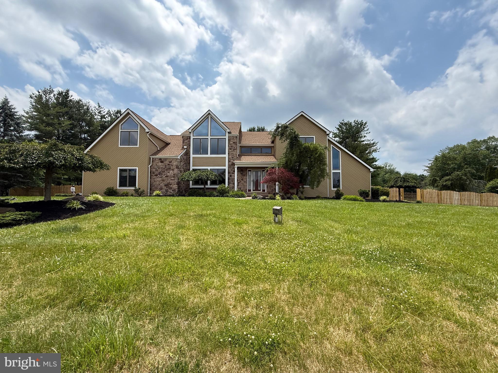 Get ready for an exciting renovation! This 4-bedroom, 3-bathroom home is almost 4,000 square feet on an acre of land in Northampton Township, right in the award-winning Council Rock School District. Welcome to Brookwood Estates, a peaceful neighborhood just minutes from local parks, golf courses, and walking trails. The home is currently being prepared for showings soon. It’s been recently painted inside and out, with meticulous attention to trim and crown molding, renovated bathrooms, new hardwood floors, a new roof within the past few years, and a new AC unit installed in 2021. As you step inside, you’ll be greeted by a beautiful two-story foyer with a formal dining room and living room. The downstairs office is breathtaking with vaulted ceilings and beautiful skylights. The family room features a wood-burning fireplace and a sliding door that opens to a large deck overlooking a serene backyard. You must see the spacious kitchen featuring vaulted ceilings, another staircase, an island, a separate sitting area, and another sliding glass door to the backyard. The first floor is complete with new hardwood floors, a renovated full bathroom, and a large laundry/mud room with another access to the backyard and two car garage. The hardwood floors have also been updated on the second floor, along with two full bathrooms and four spacious bedrooms. The master bedroom is truly stunning, featuring vaulted ceilings and gorgeous windows. It also has two walk-in closets and two bonus rooms that could be an ideal nursery, a cozy sitting room, or even a second office. Imagine the possibilities! The basement is completely unfinished, and the acre of land offers plenty of potential for renovating an existing pool into your dream pool.