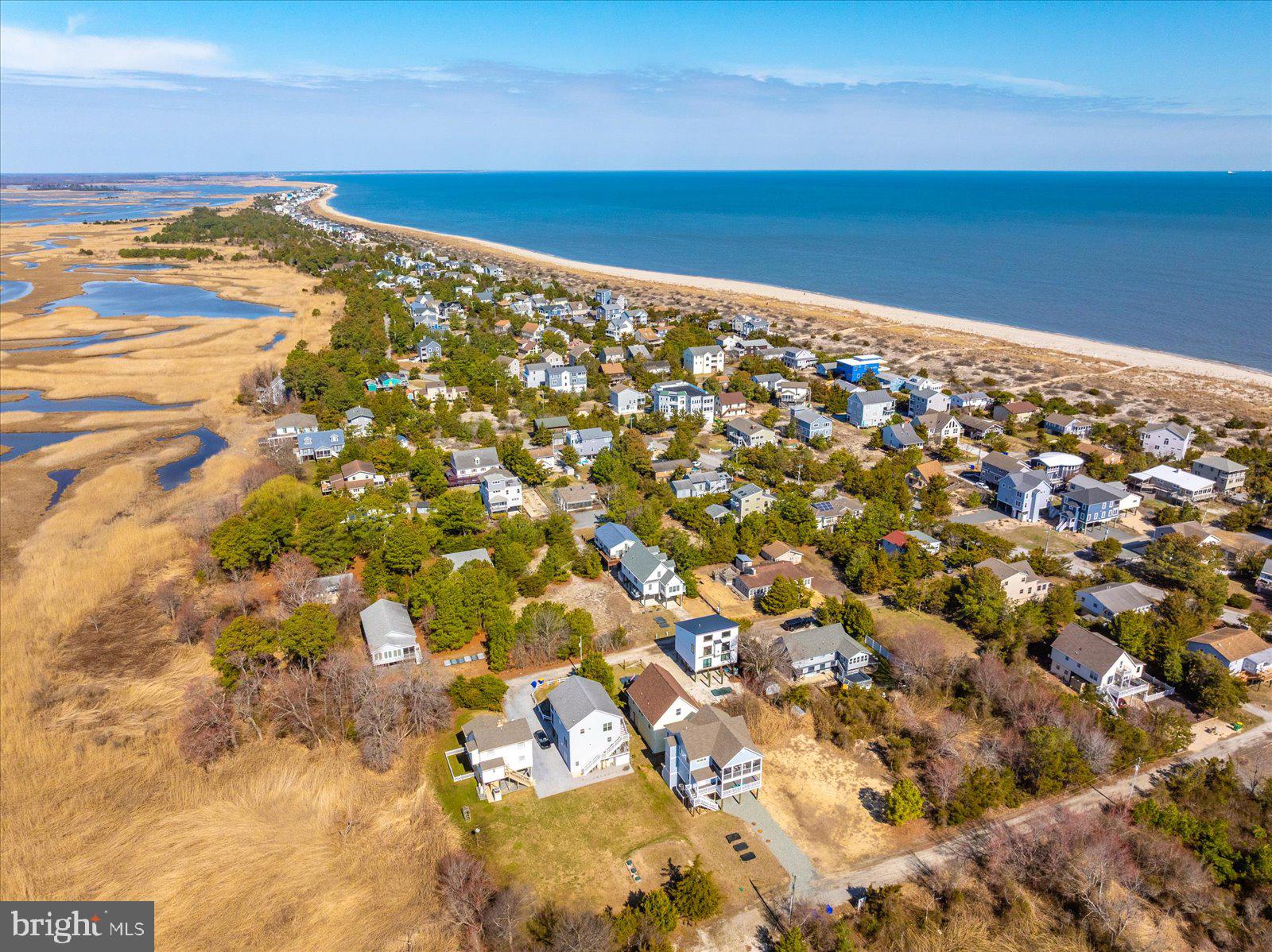 Turnkey property SOLD FULLY FURNISHED and ready to enjoy, or rent!   Just bring your  flip flops, beach towel  and cooler!  Nestled in Broadkill Beach, between the Broadkill Sound and the beaches of the Delaware Bay, this elevated Cape Cod style home is a nature-lovers dream.  Situated in the heart of this rustic, tranquil community, the property offers a peaceful retreat with outdoor living areas, and ample storage for beach toys, crabbing and fishing equipment.  Escape to the private owner's suite in the eaves of the second level and allow your guests to enjoy the sights and sounds of this secluded sanctuary.  Just one block to the sand of the quite local beach, this bird watchers paradise is an ideal summertime getaway for the outdoor sportsperson that wants to escape the hustle and bustle.  Directly on the Prime Hook National Wildlife Refuge and far enough off Coastal Highway to allow you to feel 'off the grid', however the home is just minutes from shopping and dining.  Close enough for convenience and far enough away to embrace the peaceful environment and see the stars overhead.  Previous rental history has generated roughly $30,000.00 in summer season!  Either for passive income generation, for your own enjoyment, or for both!  This property is a great opportunity.