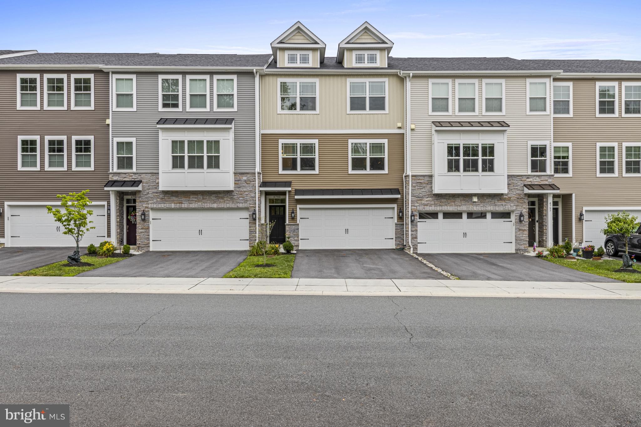 This 3BR, 2.1 bath newer construction townhome is completely move-in ready. Beautifully upgraded and low-maintenance it is set in the sought-after Overlook at Linden Run community. This turnkey residence combines modern finishes, thoughtful enhancements, and exceptional convenience with scenic views from the back of the house. The entry level features a spacious finished walkout recreation room with a sliding glass door leading to the covered rear patio and fenced backyard. A convenient mudroom with closet lead to the front-entry two-car garage. Head upstairs to the main living level - designed for comfortable everyday living and effortless entertaining. At the center of the home is a gourmet kitchen featuring an oversized 10-foot granite island, light-colored shaker cabinetry, stainless steel appliances, abundant counter space, and generous storage. The kitchen opens seamlessly to the spacious dining area and great room with high ceilings and gray-washed wood floors. Sliding glass doors provide access to the covered porch and raised composite deck overlooking the backyard and surrounding open space. A conveniently located powder room completes this level. The upper level offers a spacious primary suite with a tray ceiling, oversized walk-in closet, and a luxurious en-suite bath featuring a double vanity, glass-enclosed shower, and private water closet. Two additional bedrooms, including one with a walk-in closet, a full hall bath, and a conveniently located laundry room complete the second floor. Ideally located just steps from the shopping and dining of Pike Creek, with easy access to major highways, this home is also within the award-winning Red Clay Consolidated School District. Greenville, Trolley Square, downtown Wilmington, the Riverfront, Kennett Square, and Wilmington Station are all within approximately 10 miles, offering the perfect balance of peaceful community living and everyday convenience.