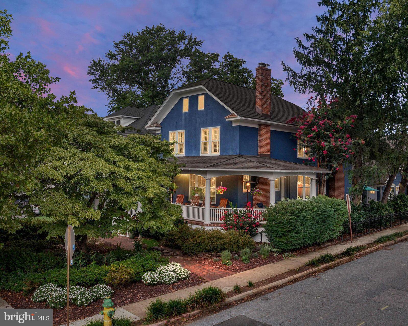 Nestled on one of the most picturesque streets in Annapolis, this utterly charming Murray Hill home blends timeless character with thoughtful modern updates. A welcoming wraparound porch overlooks the beautifully landscaped front yard, complete with a stunning dogwood tree, while the fenced backyard offers a private courtyard patio that's perfect for outdoor entertaining. A rare 24' x 22' detached two-car garage provides exceptional storage and convenience.

Inside, classic architectural details create a warm and inviting atmosphere. The gracious foyer opens to gleaming hardwood floors, oversized moldings, and elegant French doors connecting the living and dining rooms. Two gas fireplaces—one in the living room and another in the family room—add warmth and charm throughout the home. The beautifully appointed kitchen features custom cabinetry, granite countertops, a four-burner gas range with griddle and hood, and a wine refrigerator. A conveniently located powder room completes the main level. Plantation shutters throughout the home add timeless style and privacy.

The spacious family room off the kitchen features a fireplace & custom built-ins for abundant storage, while double French doors open to the delightful courtyard, seamlessly blending indoor and outdoor living.

Upstairs, the generous primary suite offers a walk-in closet and an en suite bath with dual vanities and a  walk-in shower. Two additional bedrooms share a charming hall bath featuring a classic clawfoot tub and a custom vanity installed in 2020. An open sitting area creates the perfect reading nook or home office, and the laundry is conveniently located on this level.

The third floor is home to a delightful fourth bedroom with cathedral ceilings, exposed beams, a large walk-in closet, and a private full bath—an ideal guest suite or private retreat.

The finished lower level provides exceptional flexibility with a spacious second family room featuring built-in shelving, plus an additional room currently used as a home office and fitness area. A half bath completes this level.

Additional highlights include three-zone heating and cooling, a new roof installed in 2020, and a fully encapsulated crawl space.

Ideally located on Southgate Avenue, this exceptional home offers easy walkability to downtown Annapolis, the U.S. Naval Academy, and the city's renowned shops, restaurants, and waterfront. At the end of the street, enjoy water access to Spa Creek—perfect for launching a kayak or stand-up paddleboard and embracing the Annapolis lifestyle.